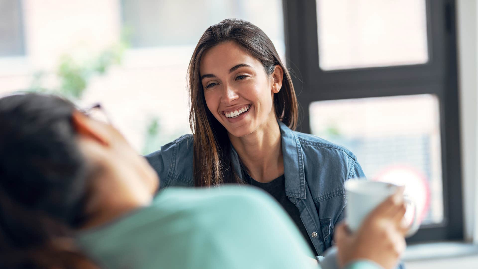 woman telling friend people are just haters as they talk over coffee 