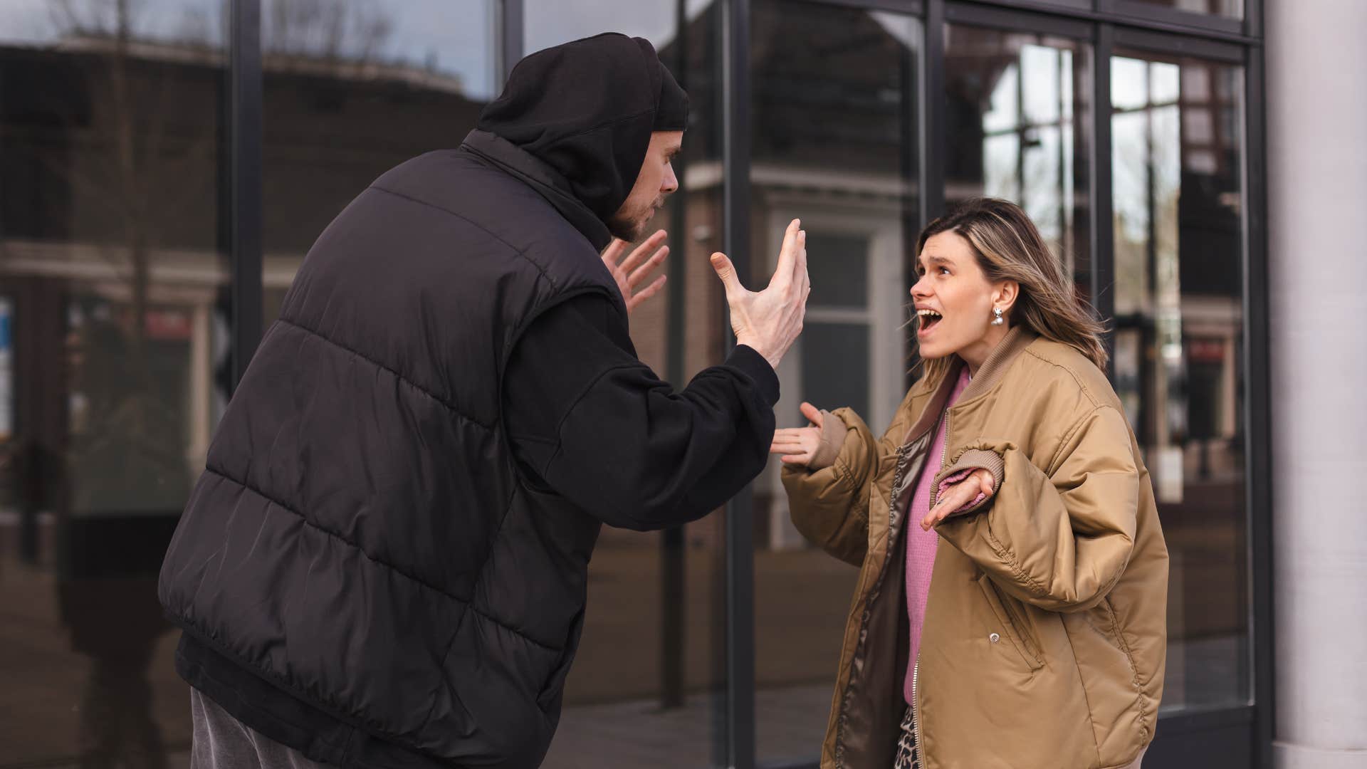 couple arguing outside as man in black coat yells why does that even matter