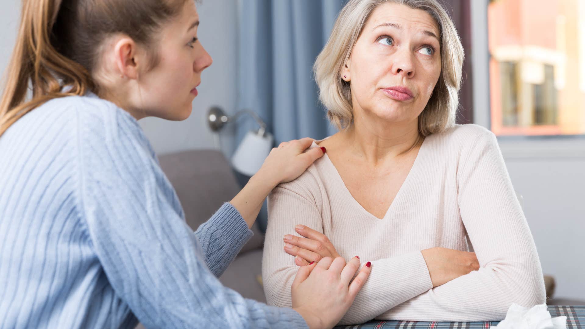 woman telling her mom no offense but