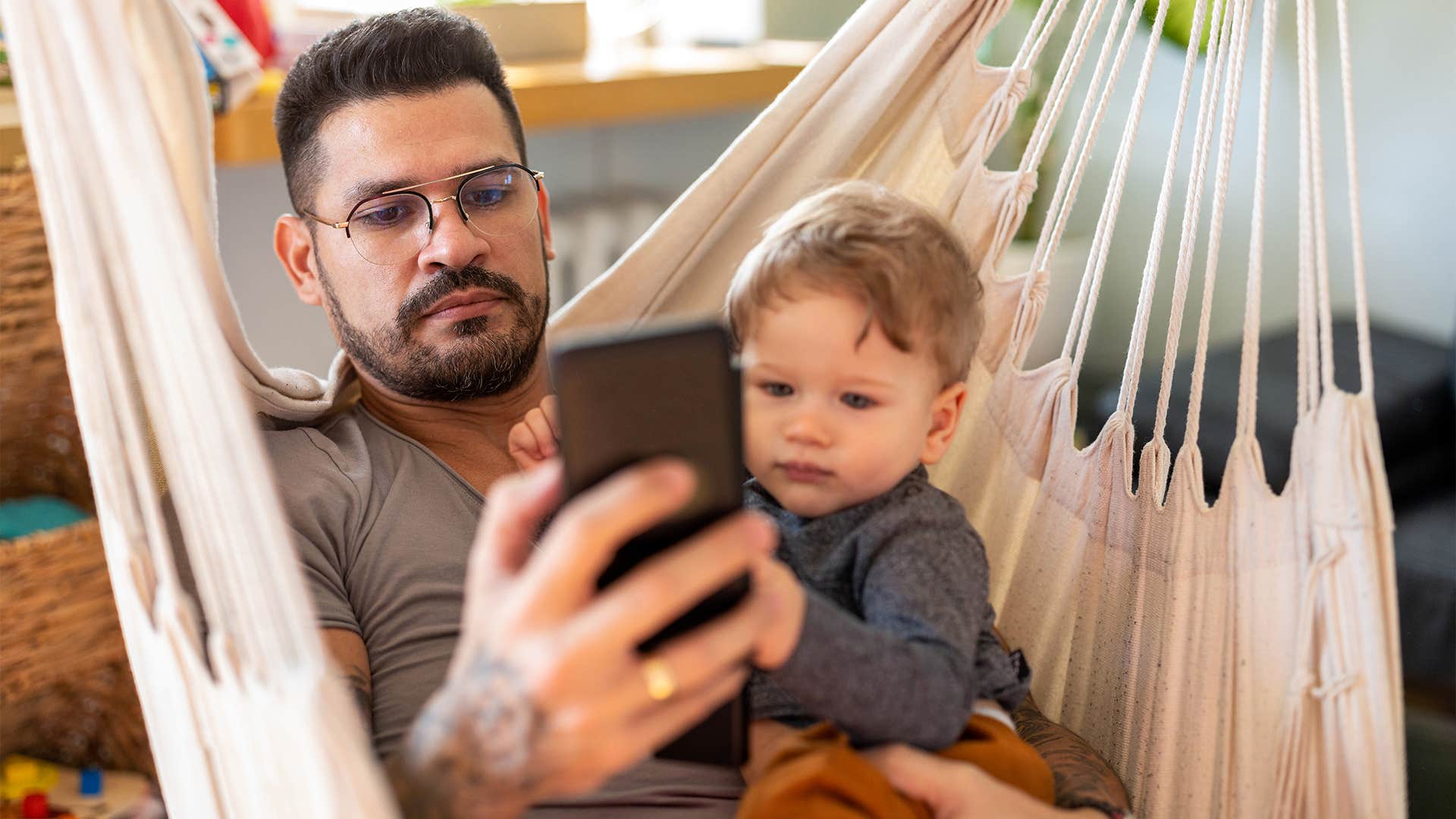 father supervising and digitally monitoring his kids