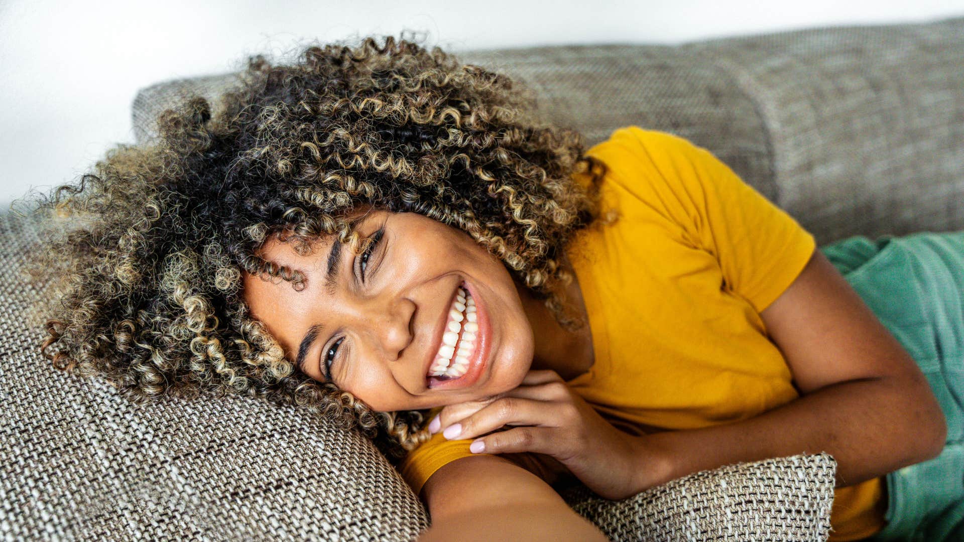 smiling woman building a strong aura by focusing on herself first
