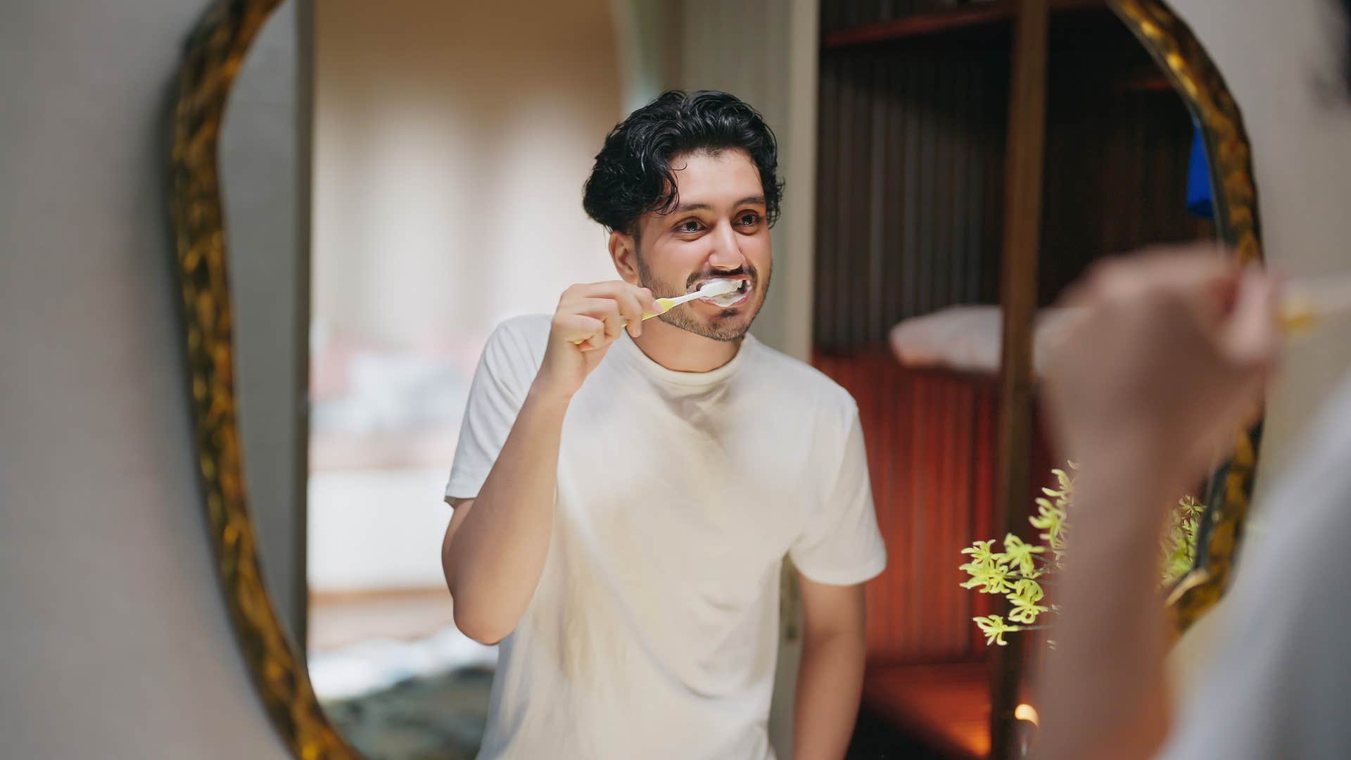 man brushing his teeth as part of daily routine