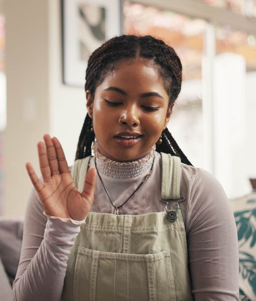 smart woman gestures to wait before responding to drama
