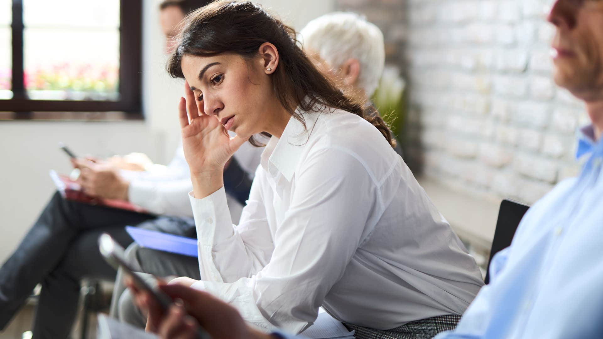 impatient woman looking annoyed in waiting room