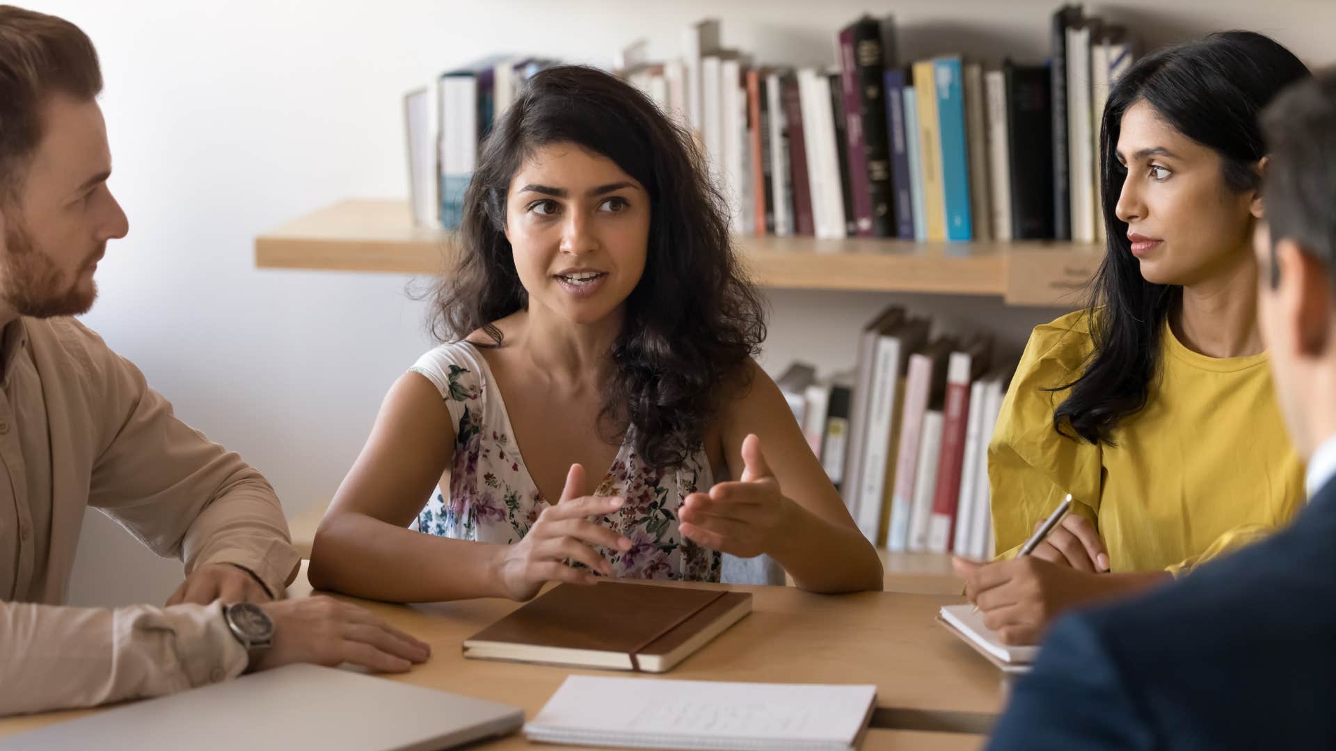 narcissistic woman physically interrupting colleagues during conversation