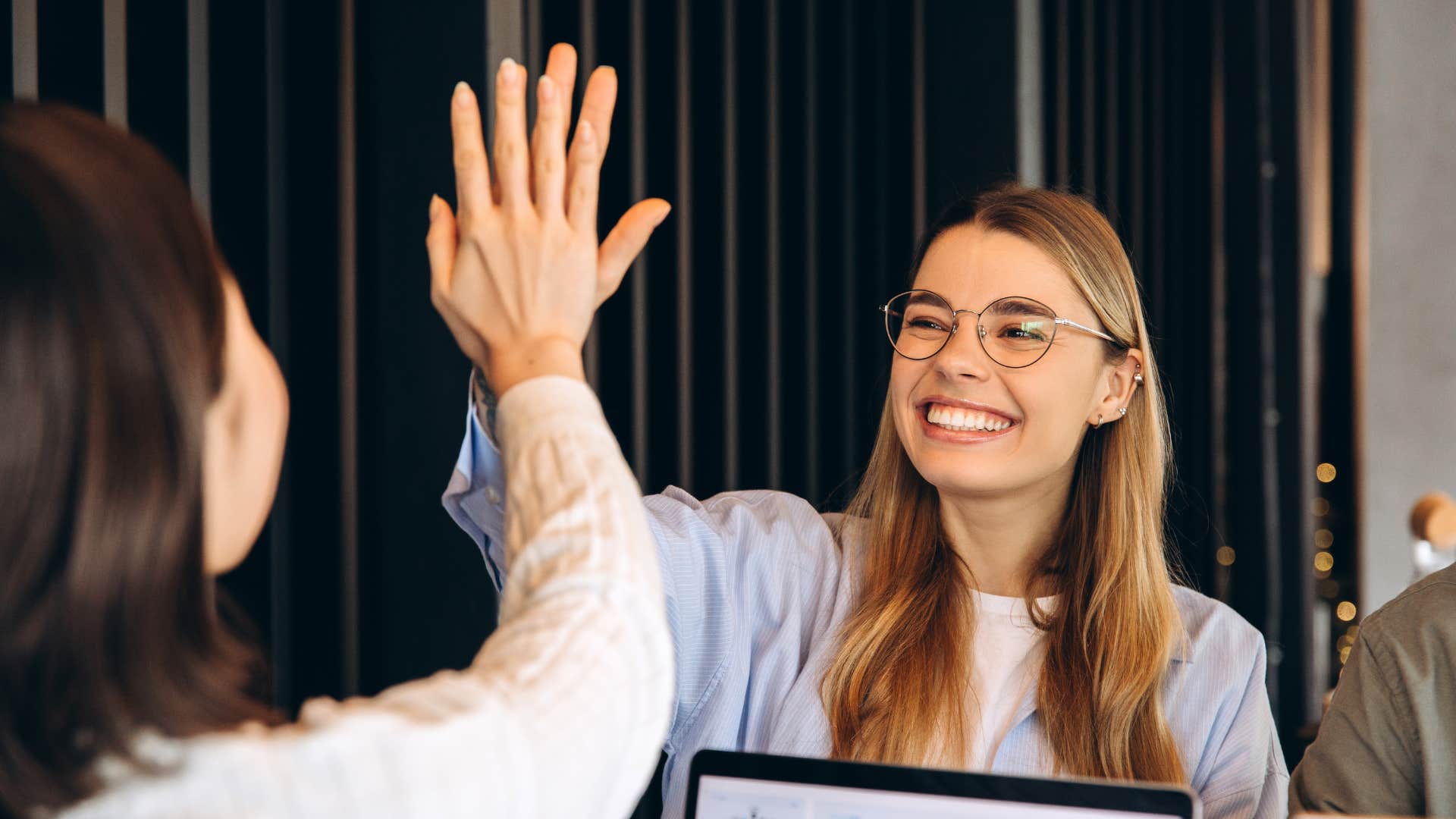 women high fiving one another as they give credit away freely