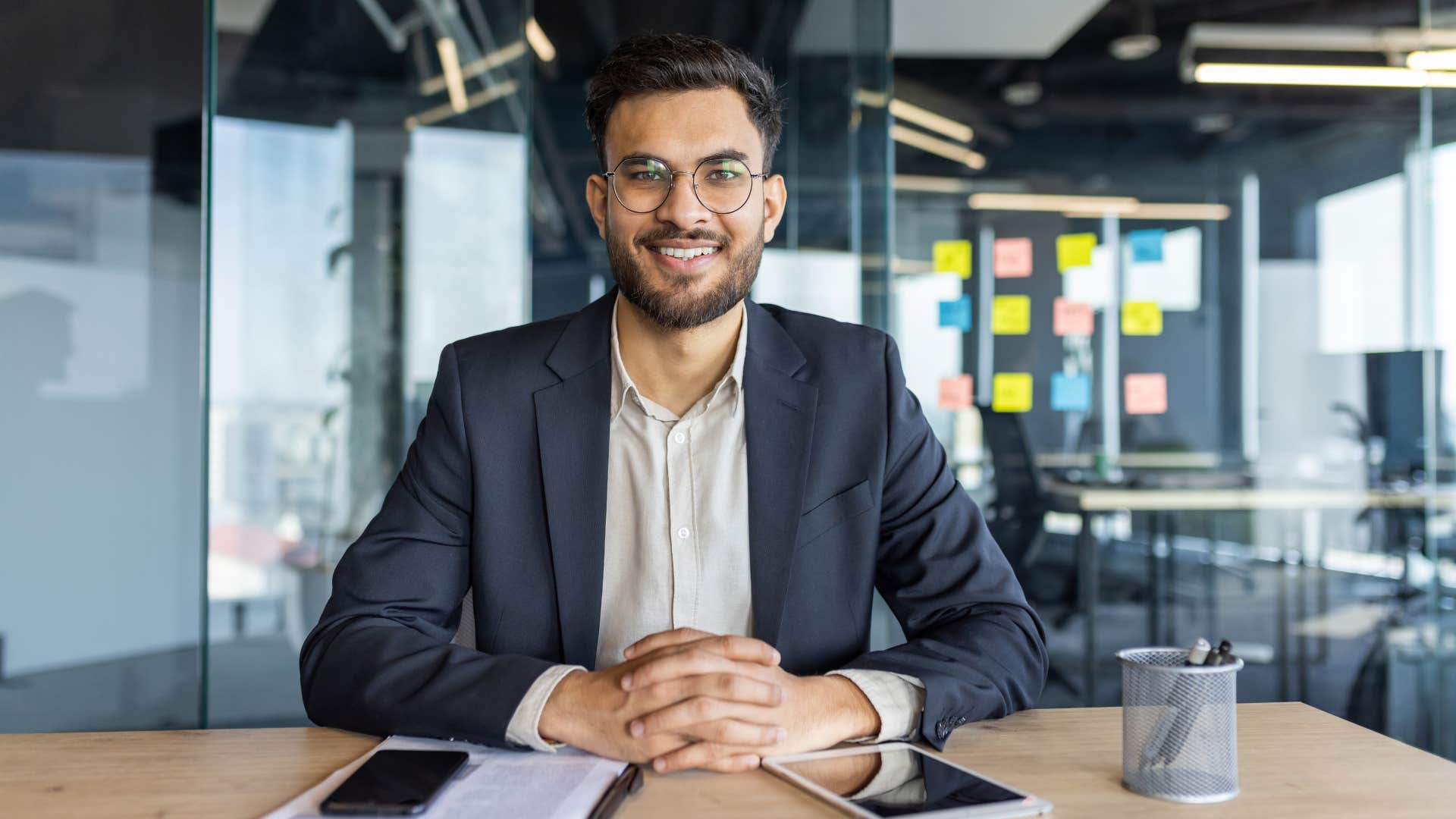 man in suit smiling as he keeps his cool no matter what people say or do