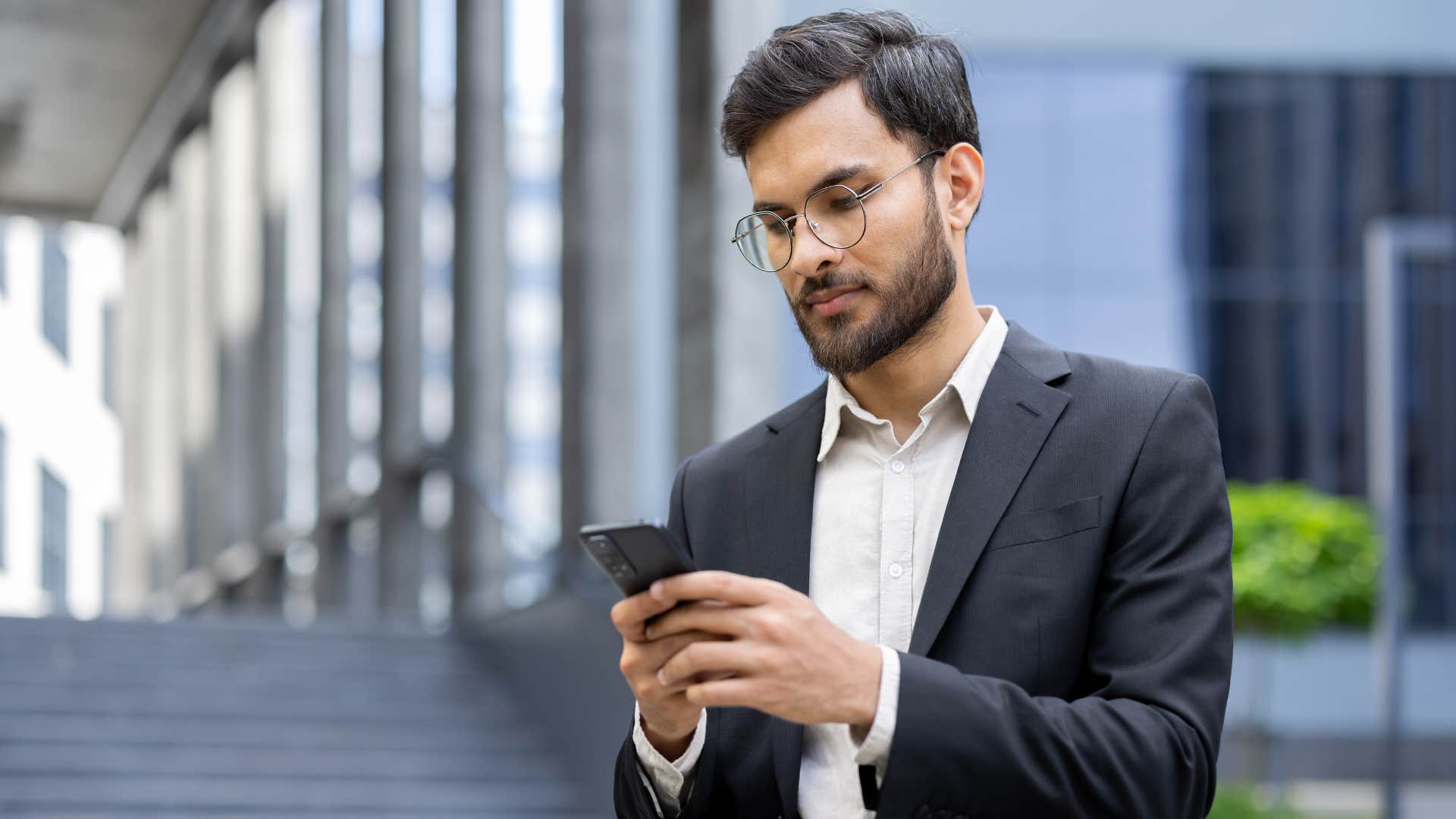 man in suit texting as they take a long time to get back