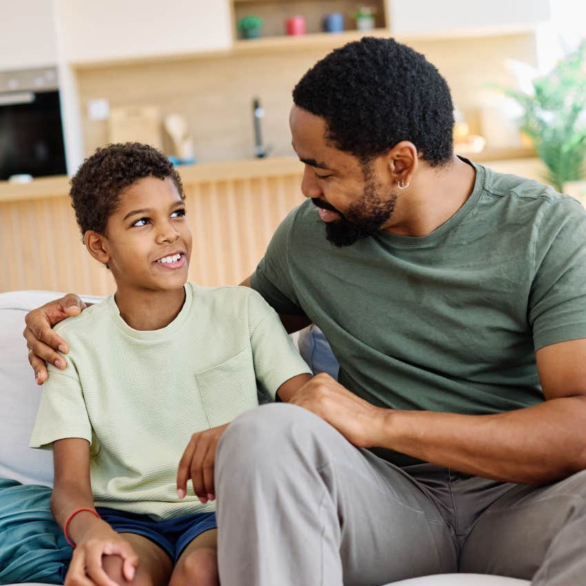 dad sitting with son on couch talking