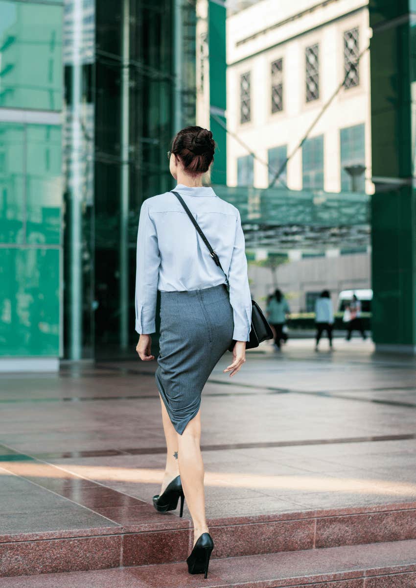 woman confidently walking into office building
