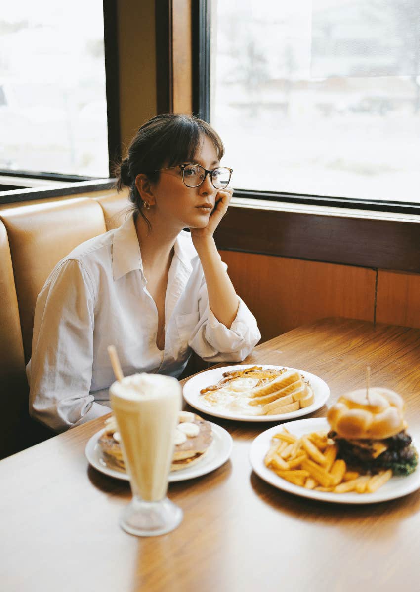 woman eating alone in diner