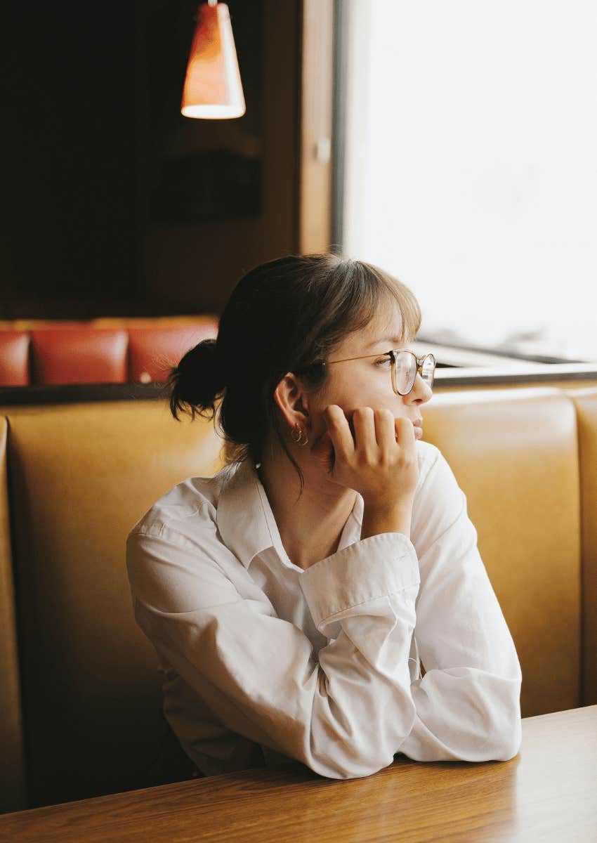 woman feels something off looking out of window