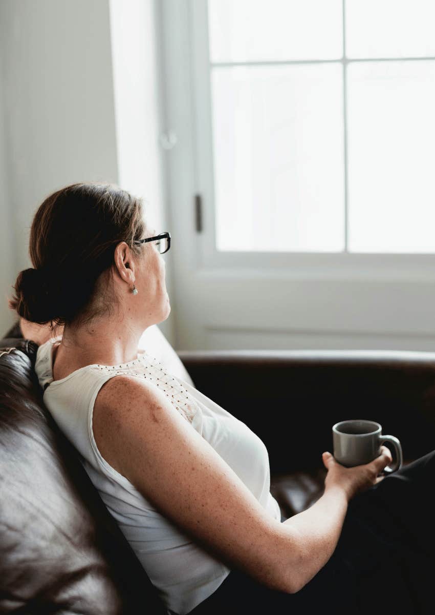 woman having a quiet moment at home on couch