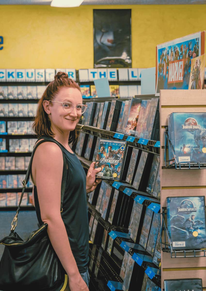 woman hold up movie rental
