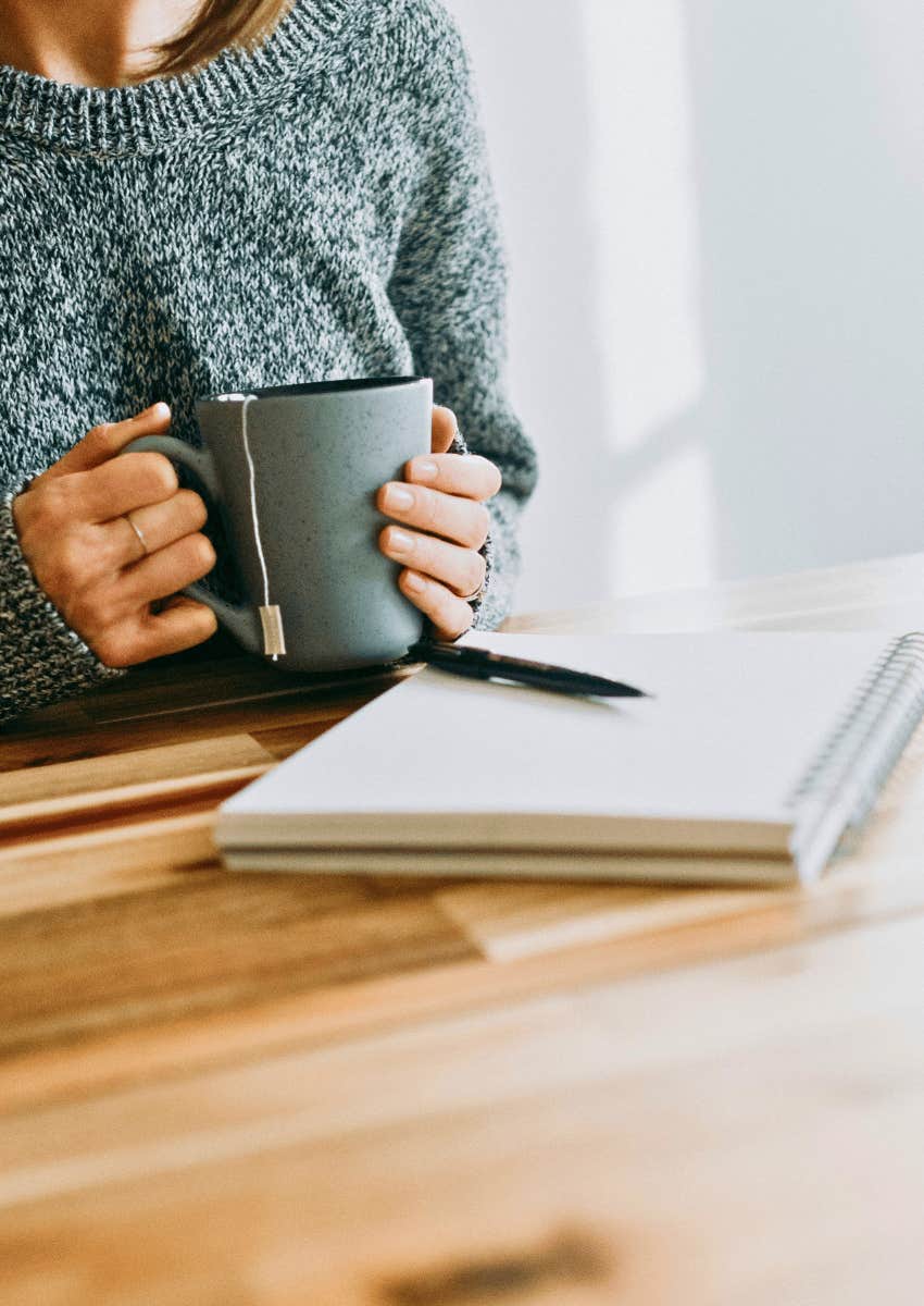 woman journaling with her morning coffee
