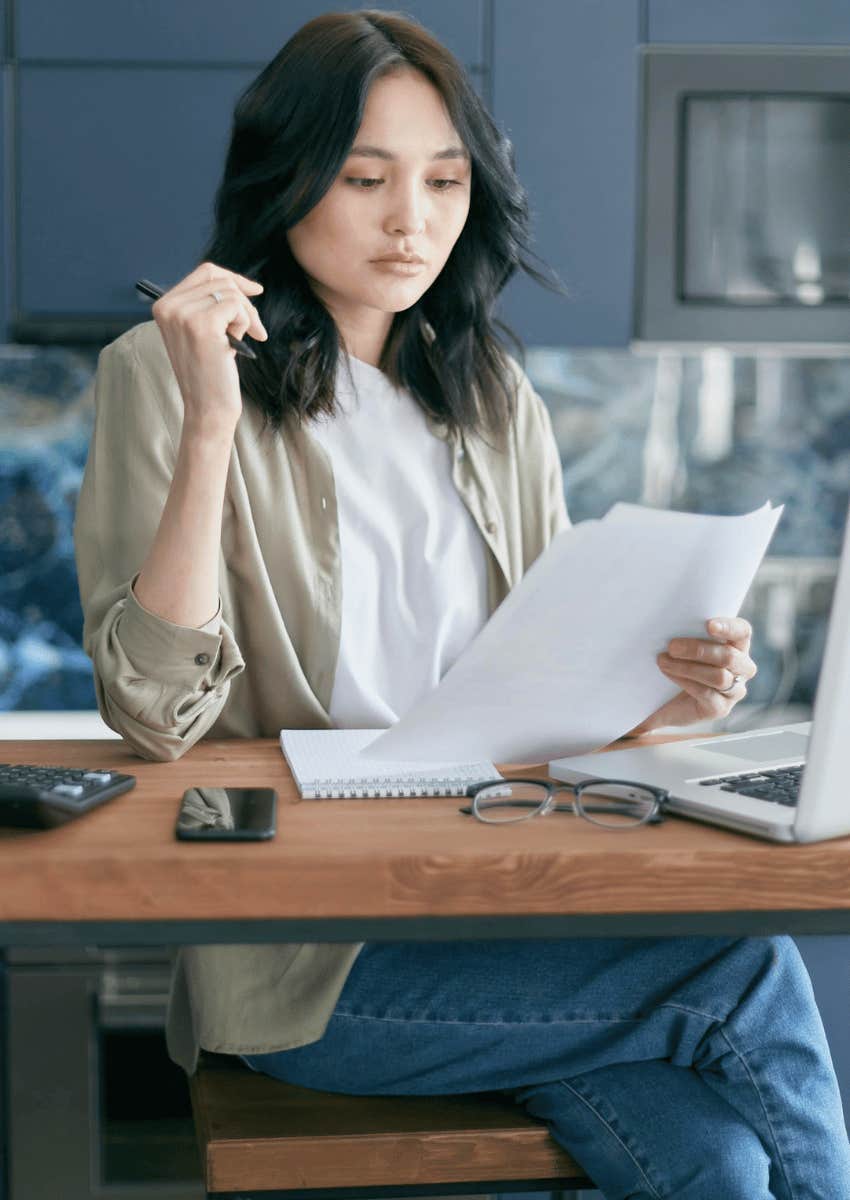 woman looking at documents at table
