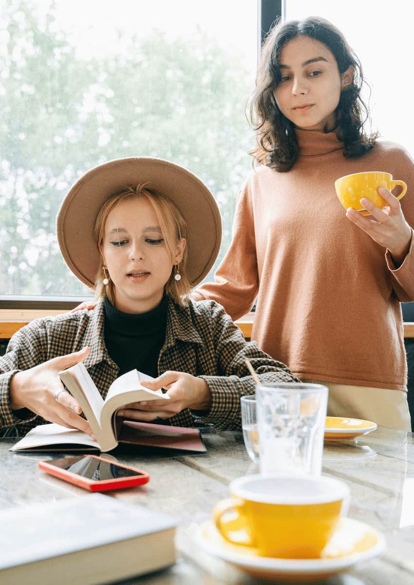 woman sharing a story to a disinterested friend