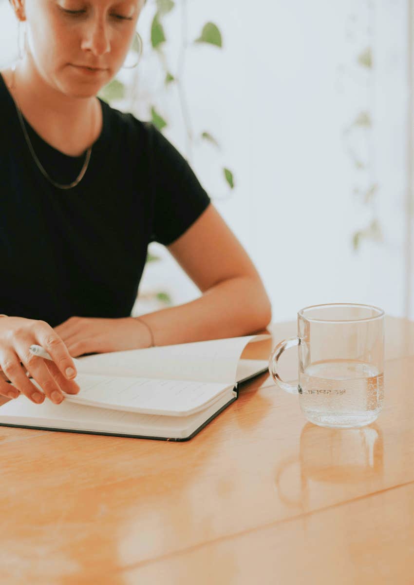 woman sitting alone journaling