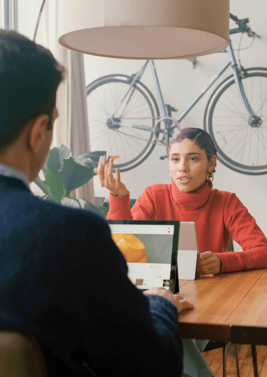 woman talking with man across desk