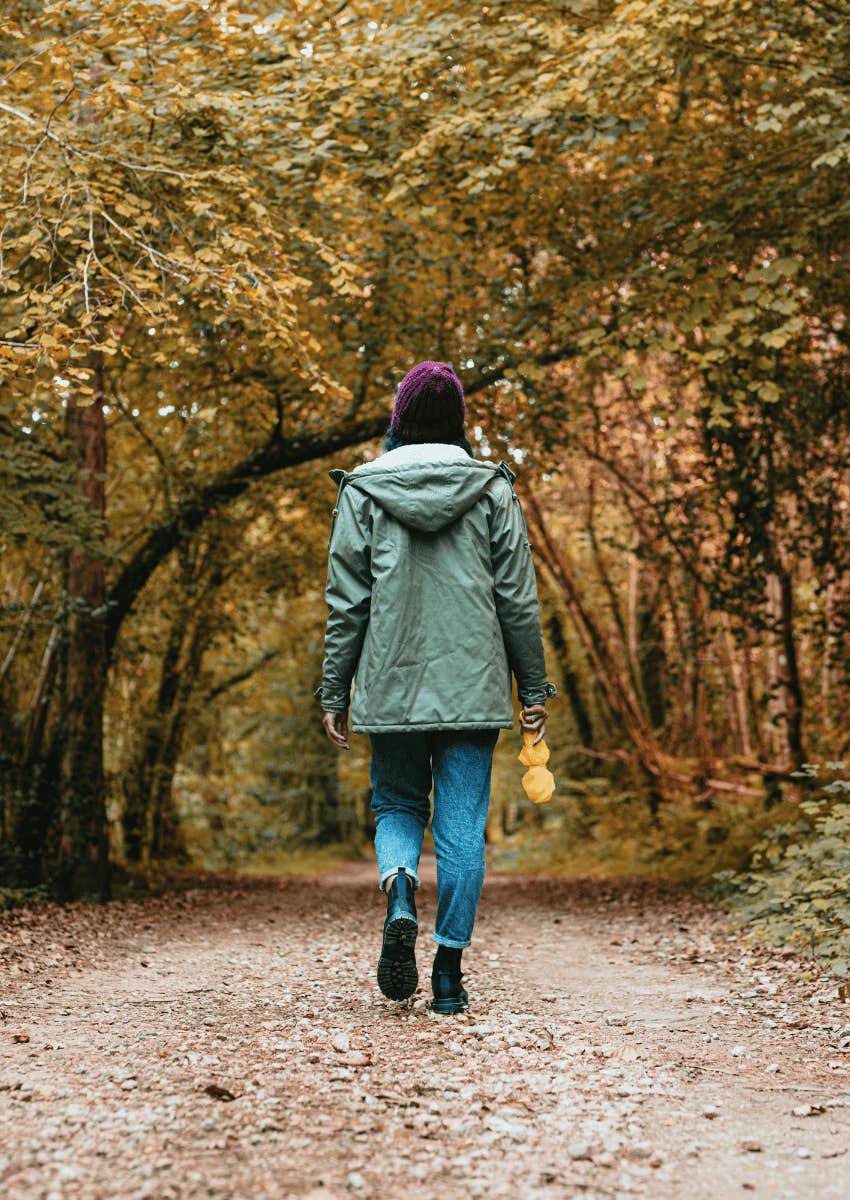woman walking down a path alone