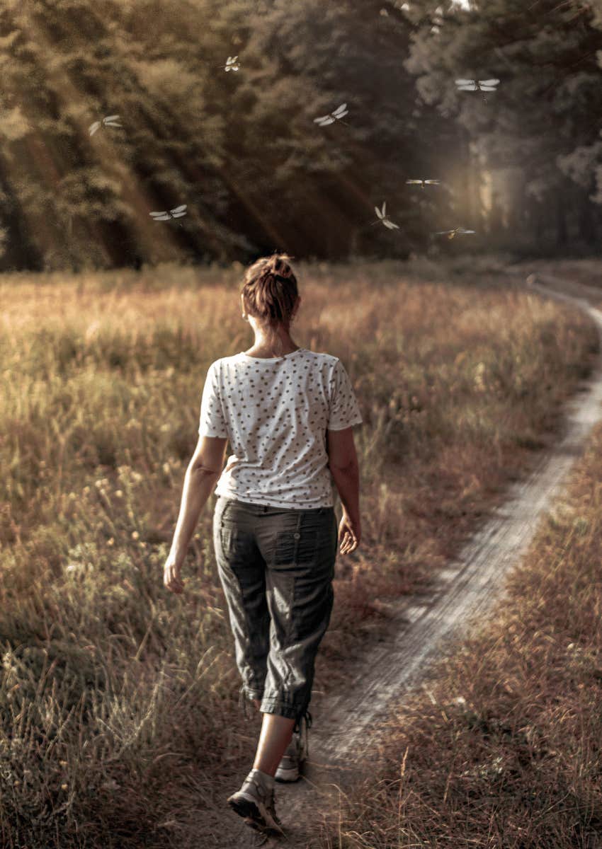 woman walking forward on nature path