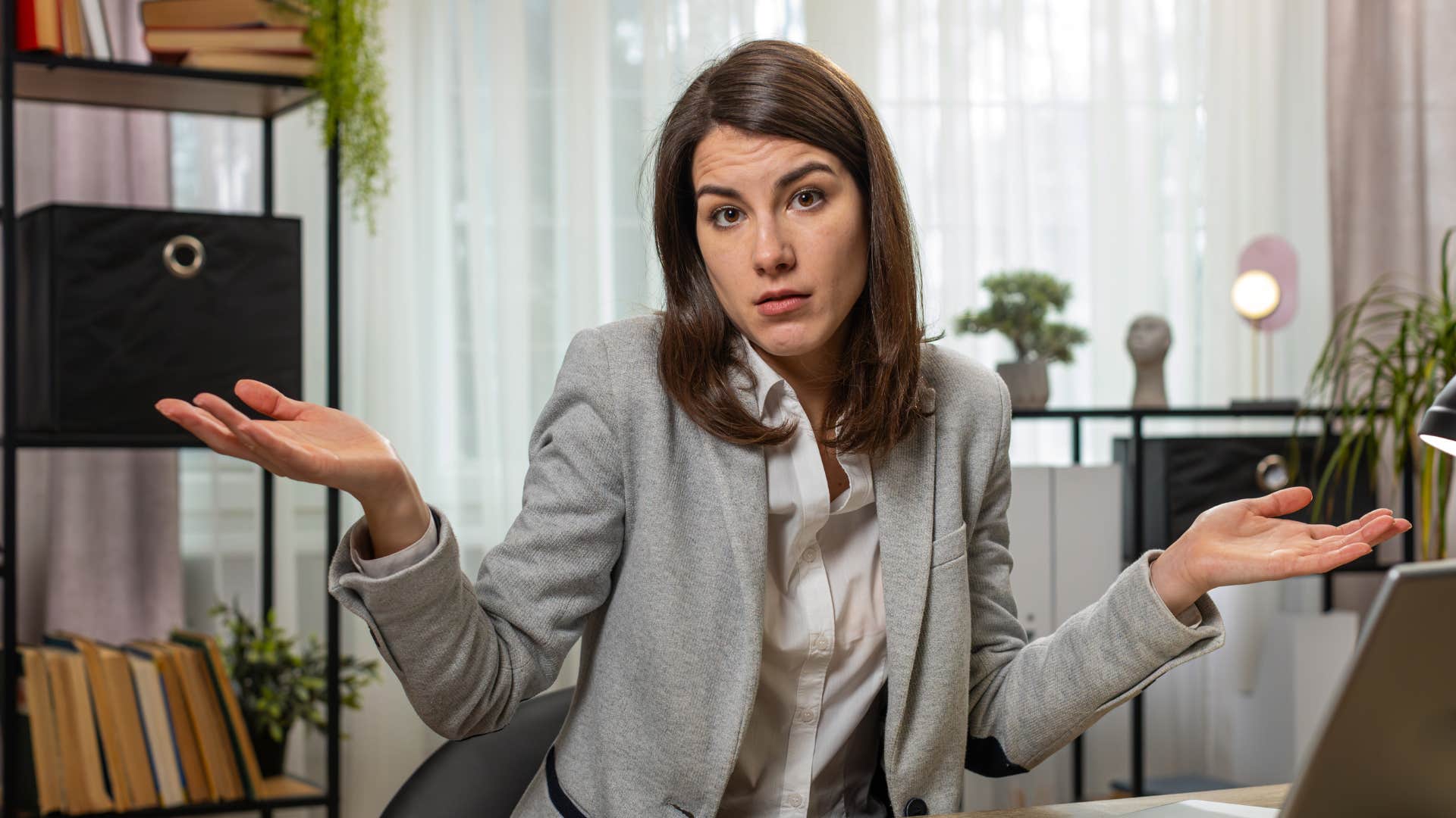 woman lacking self-respect shrugging at work