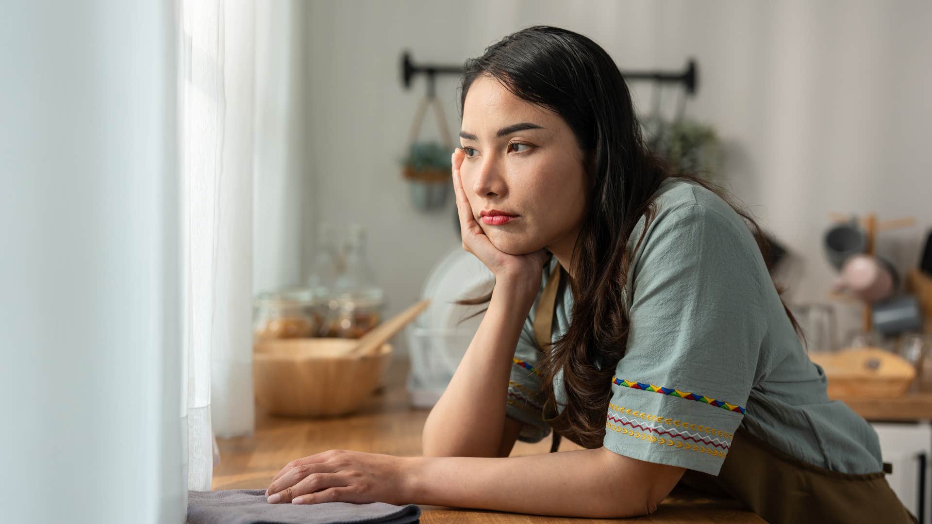 sad woman in kitchen thinking my opinion doesn't matter