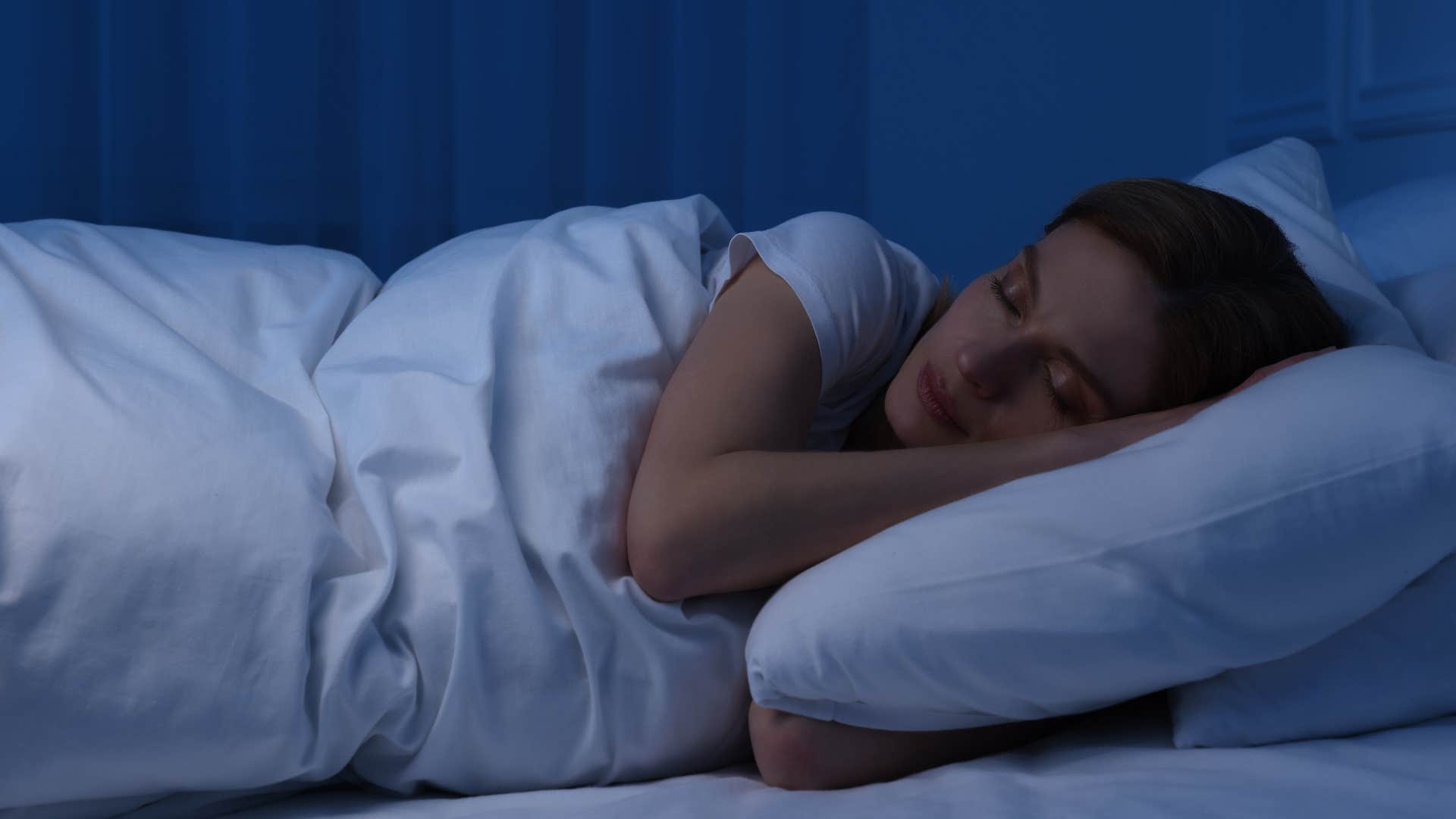 tired woman sleeping in bed feeling unhappy with her life