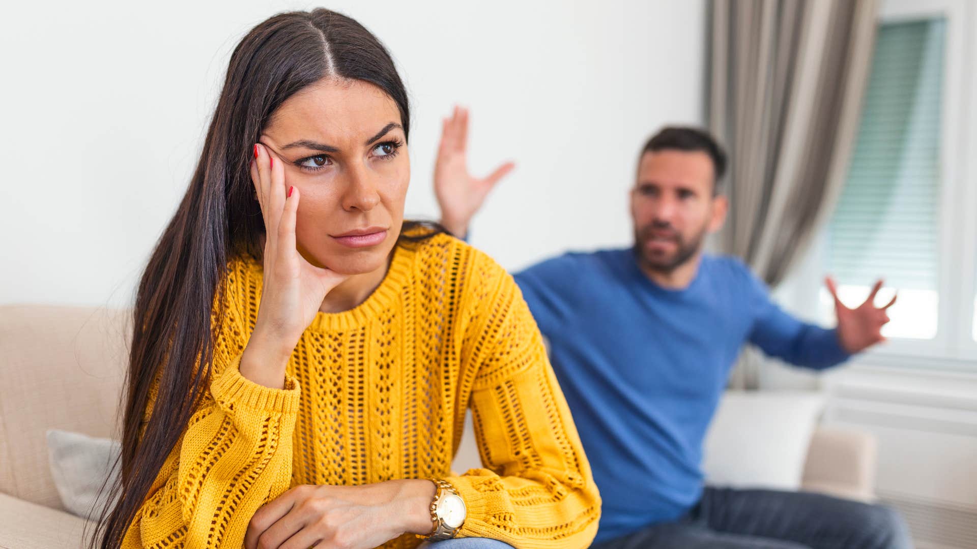 unhappy woman turned away from upset partner saying i don't have time to think about that