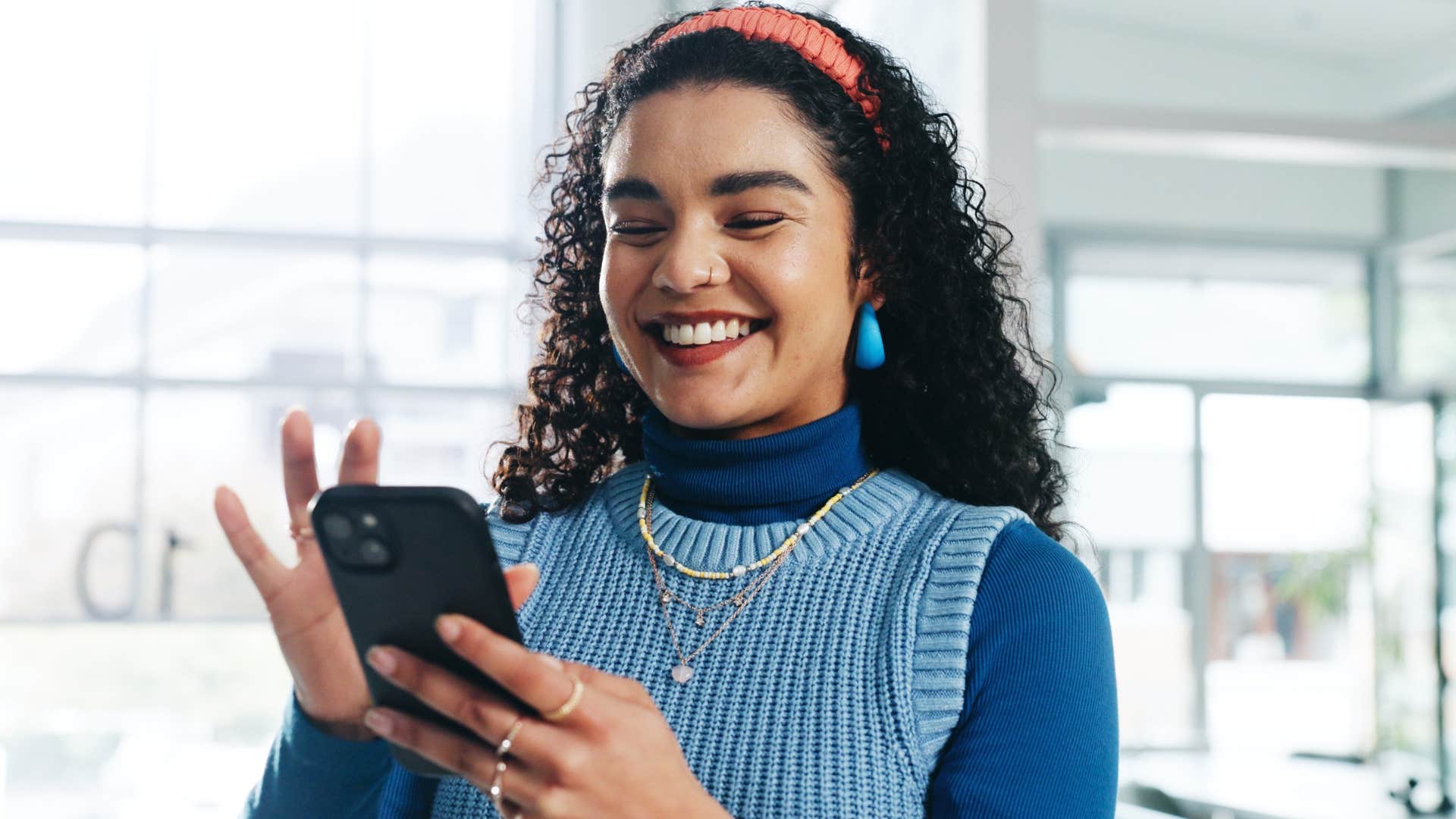 happy woman on her phone not comparing herself to others