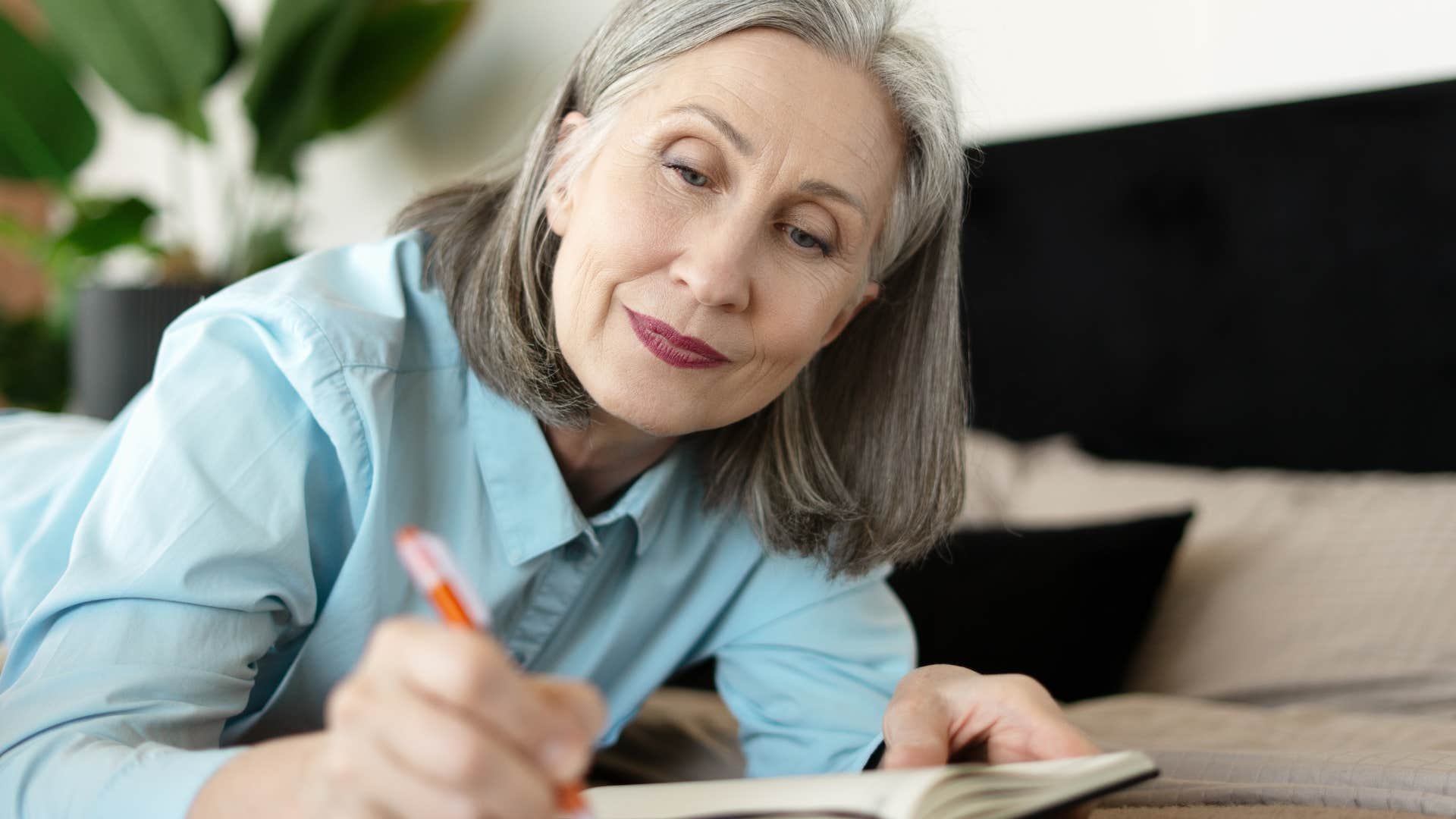 woman finding meaning in her life journaling at home