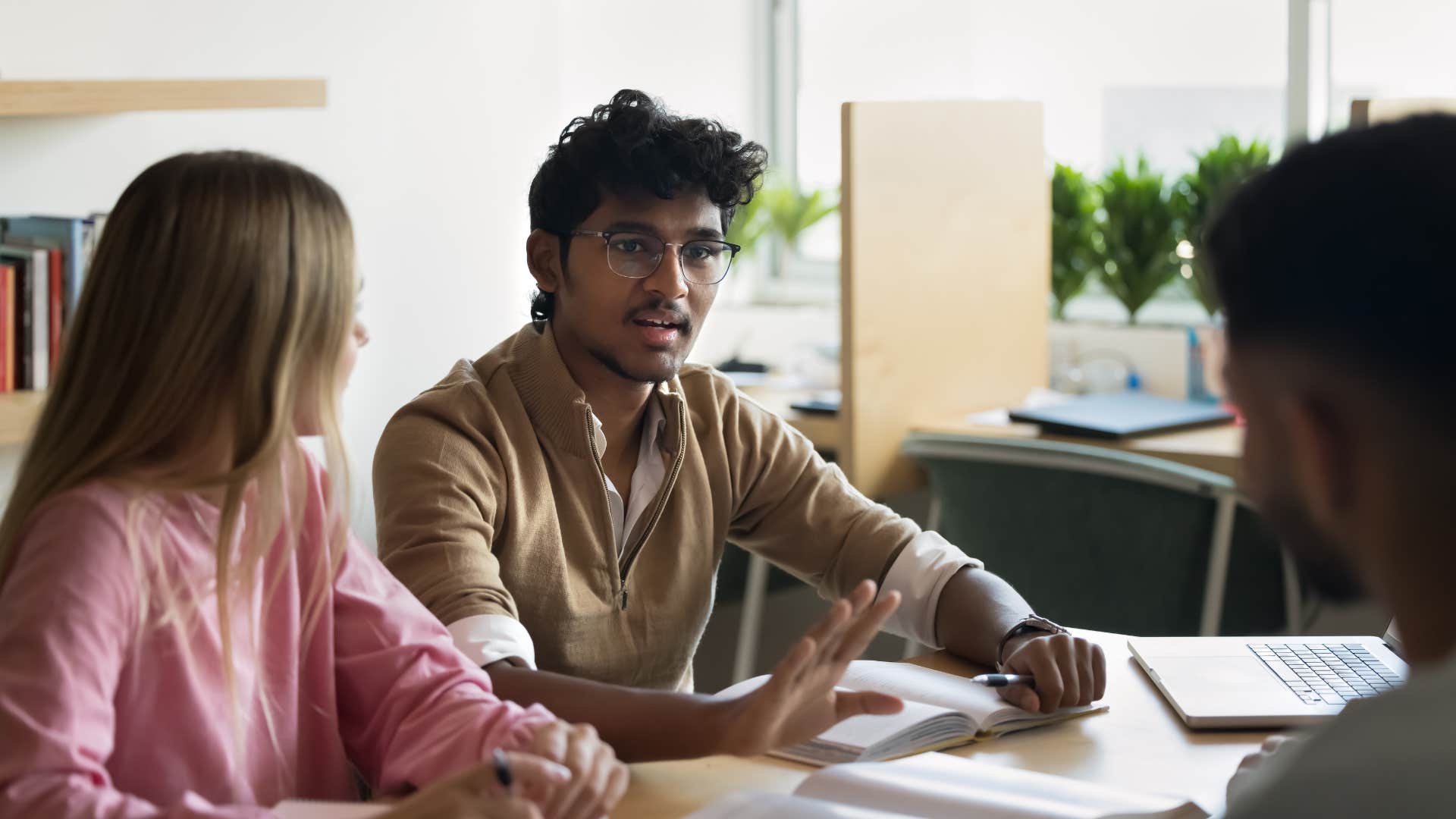 intelligent man telling colleagues i don't think it's that simple during work meeting