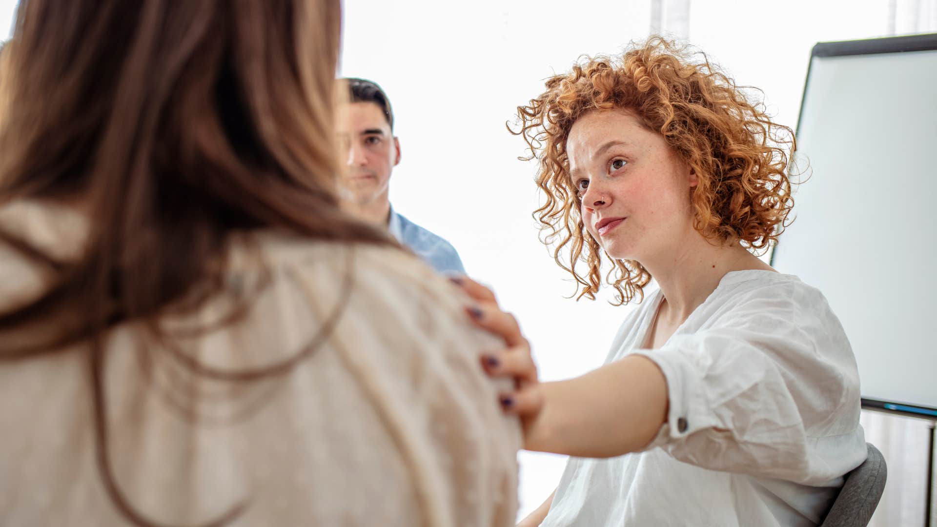 woman comforting friend saying it's not scary it's unfamiliar