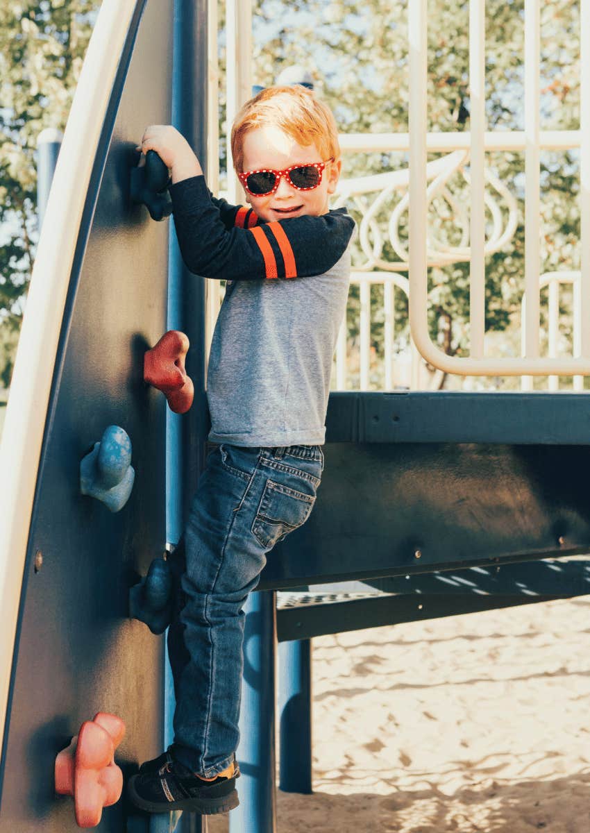 young boy on playground alone