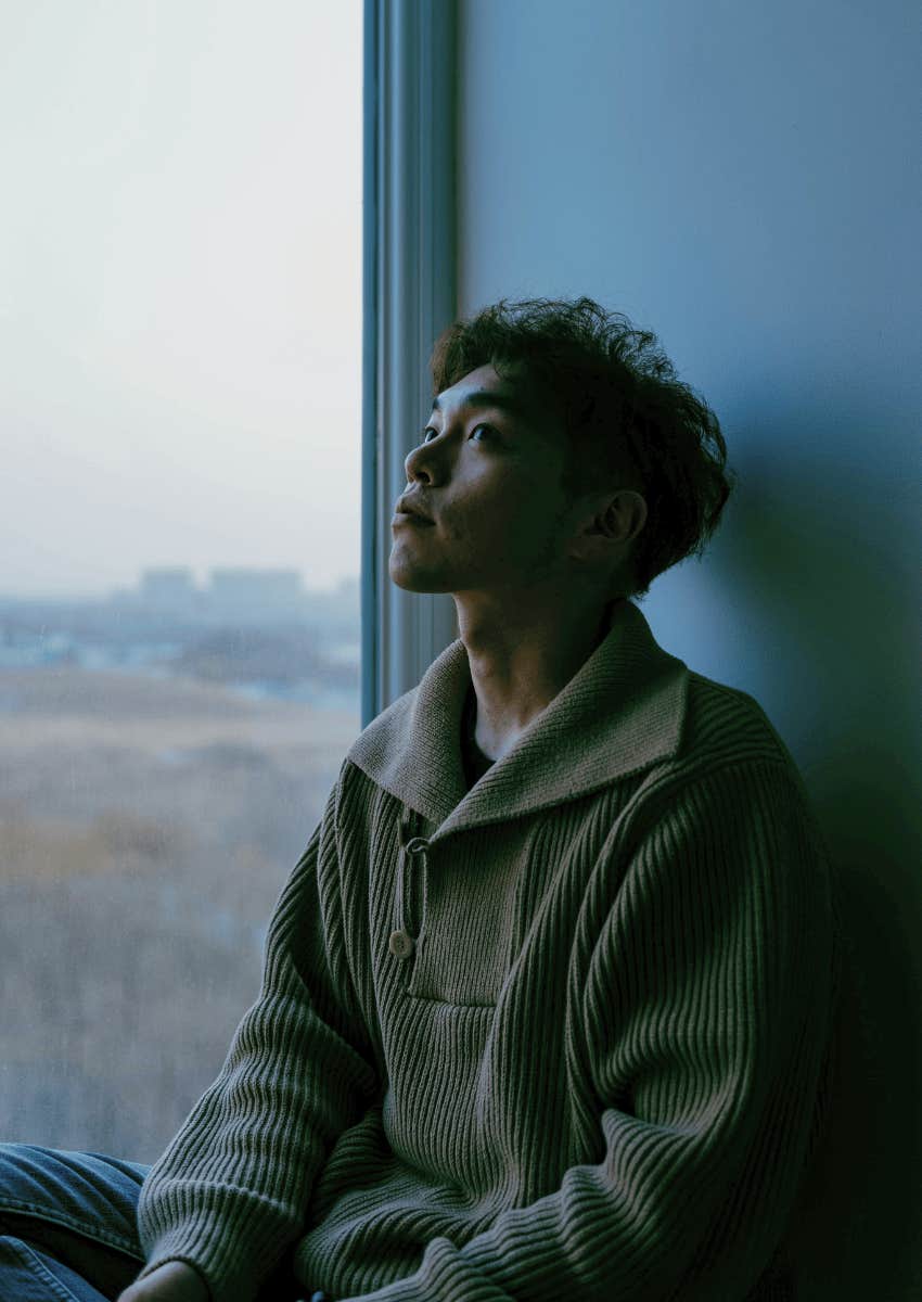 thoughtful young man sitting alone