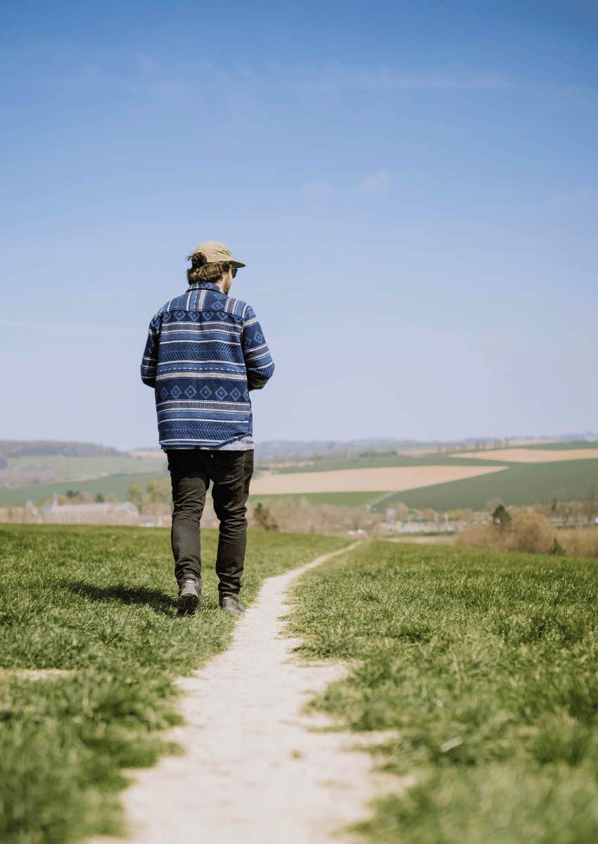young man walking down path realizing that life goes on