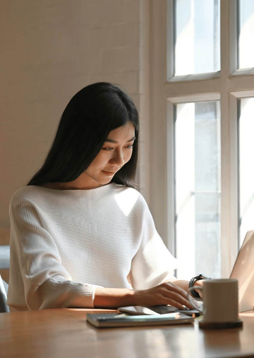 young woman focused on her laptop