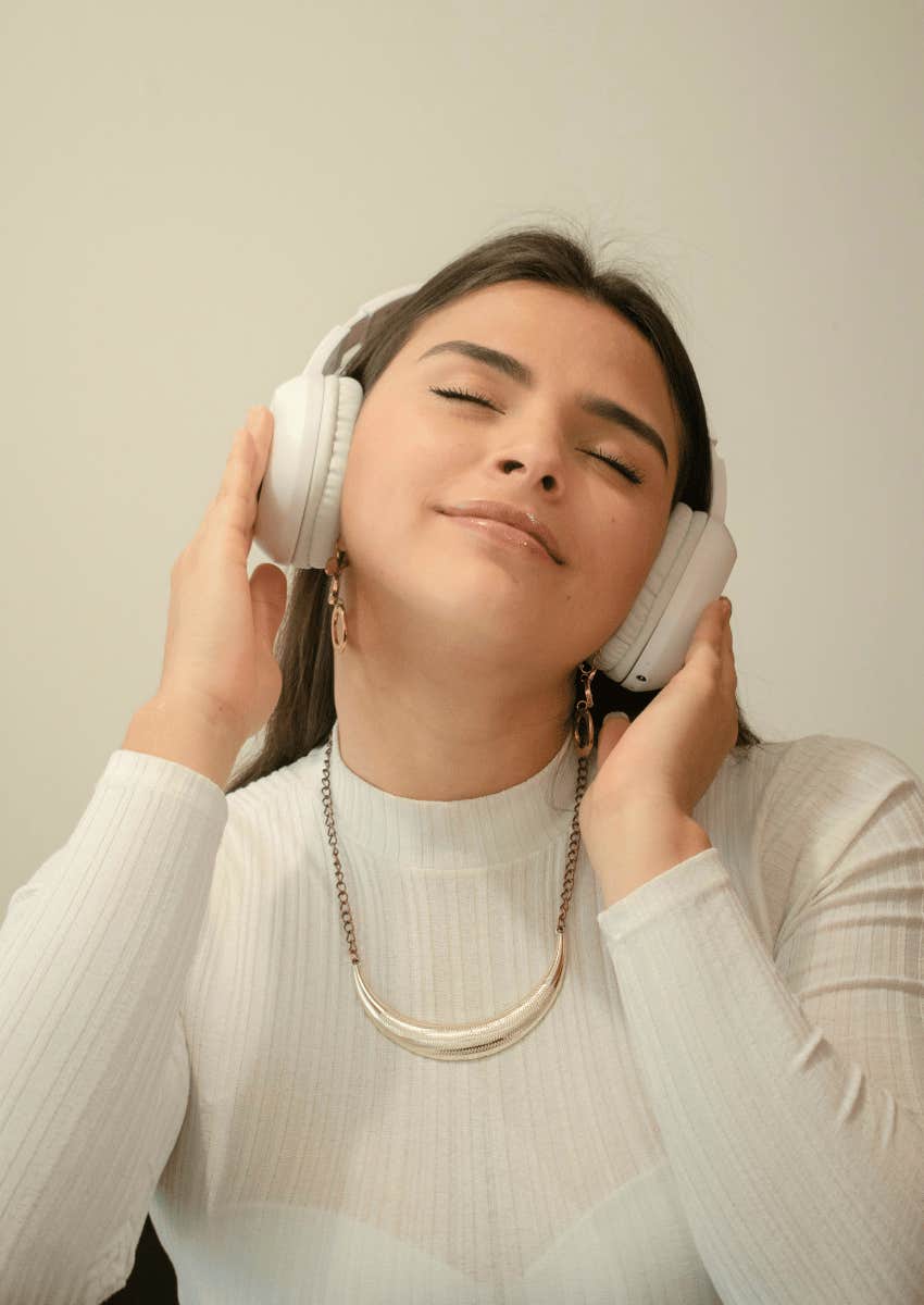 young woman wearing over-ear headphones