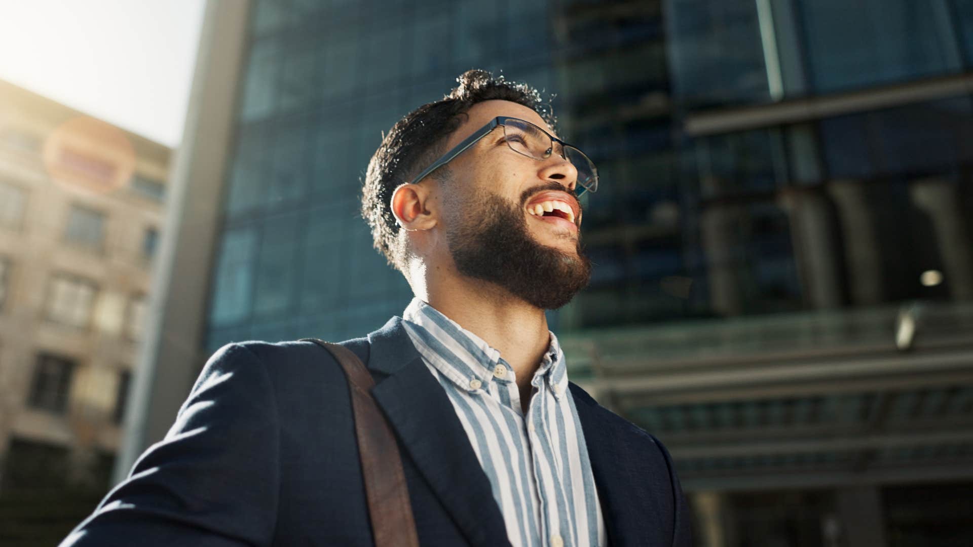man whose parents loved him unconditionally looking joyful on a city street