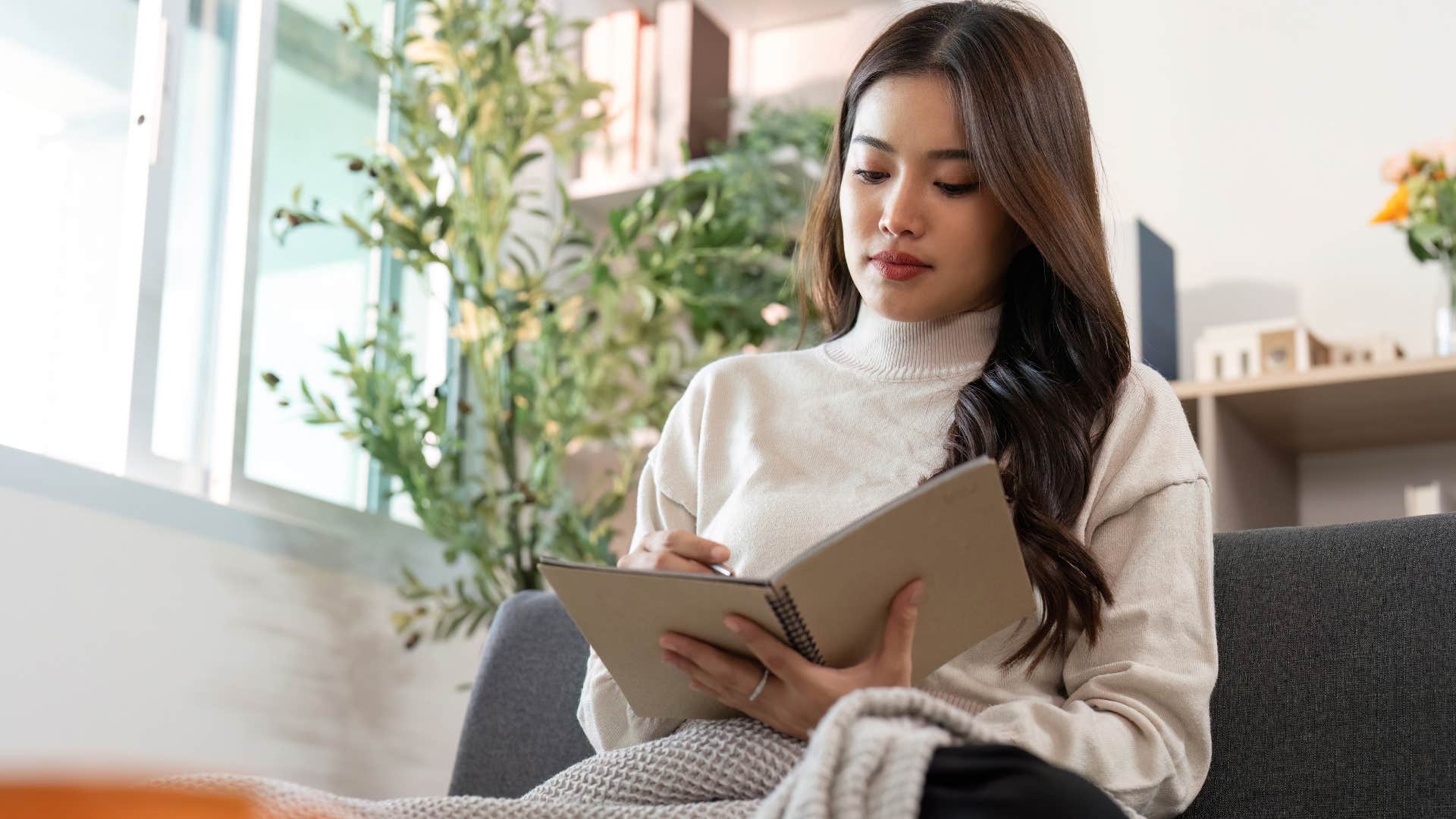 woman writing in a notebad actually knowing what her desires and values are