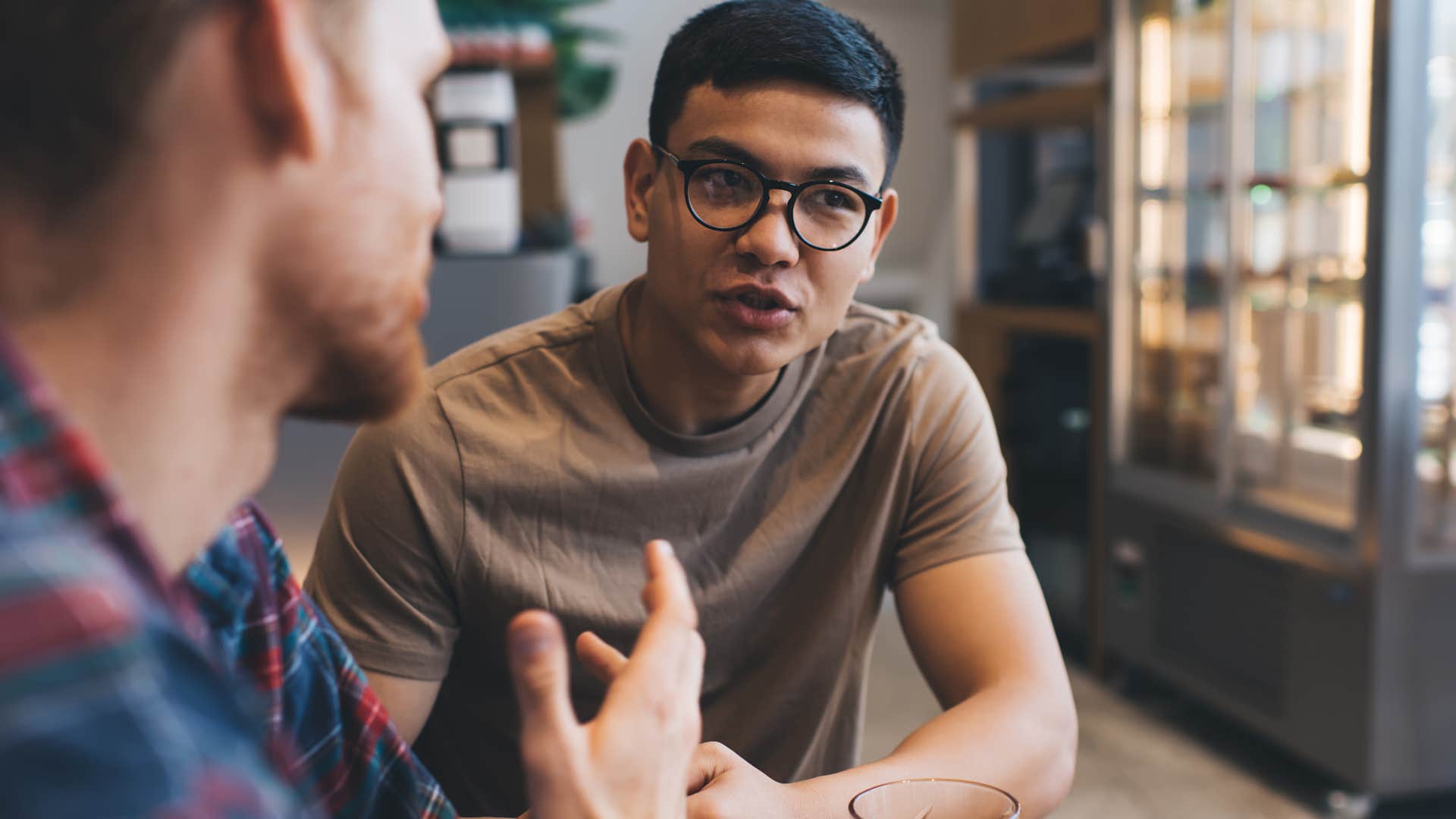 man avoiding people-pleasing behaviors in conversation with his friend