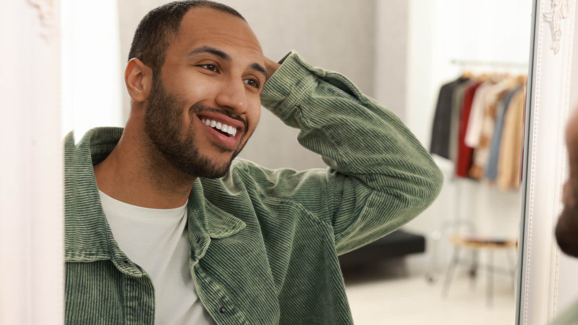 man growing his own confidence and looking in a mirror