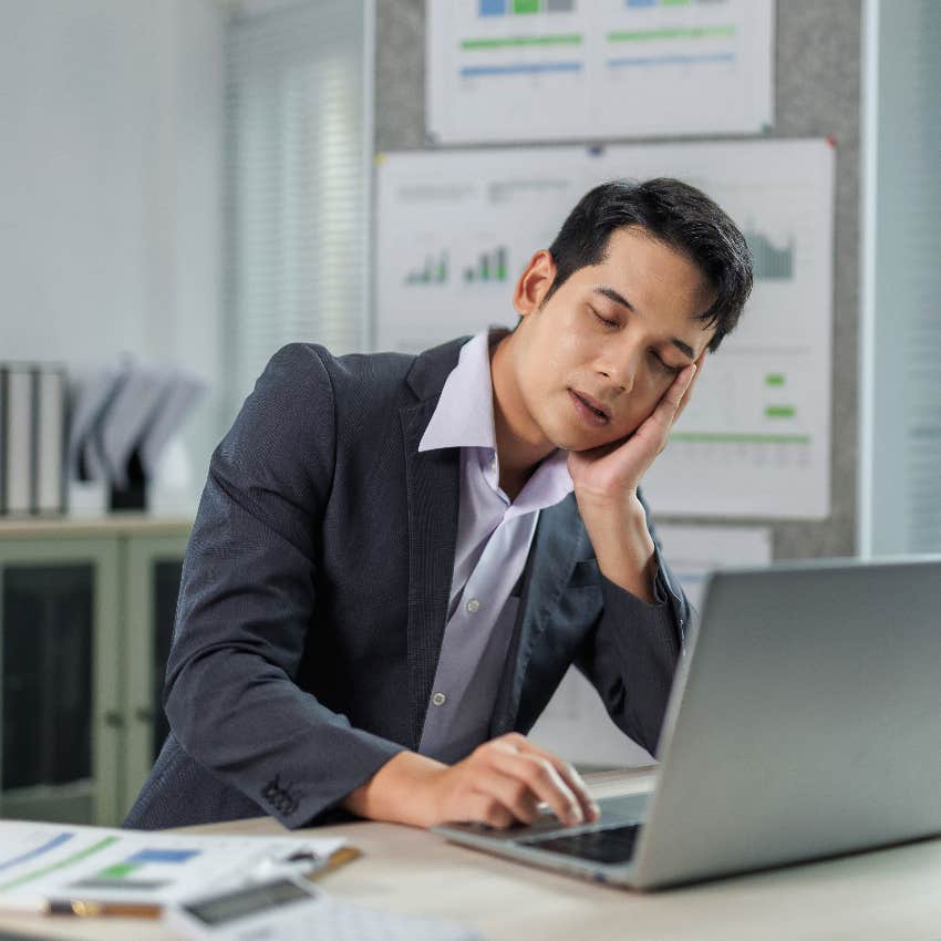 worker sleeping at desk with head on hand because he didn't get an afternoon lunch break