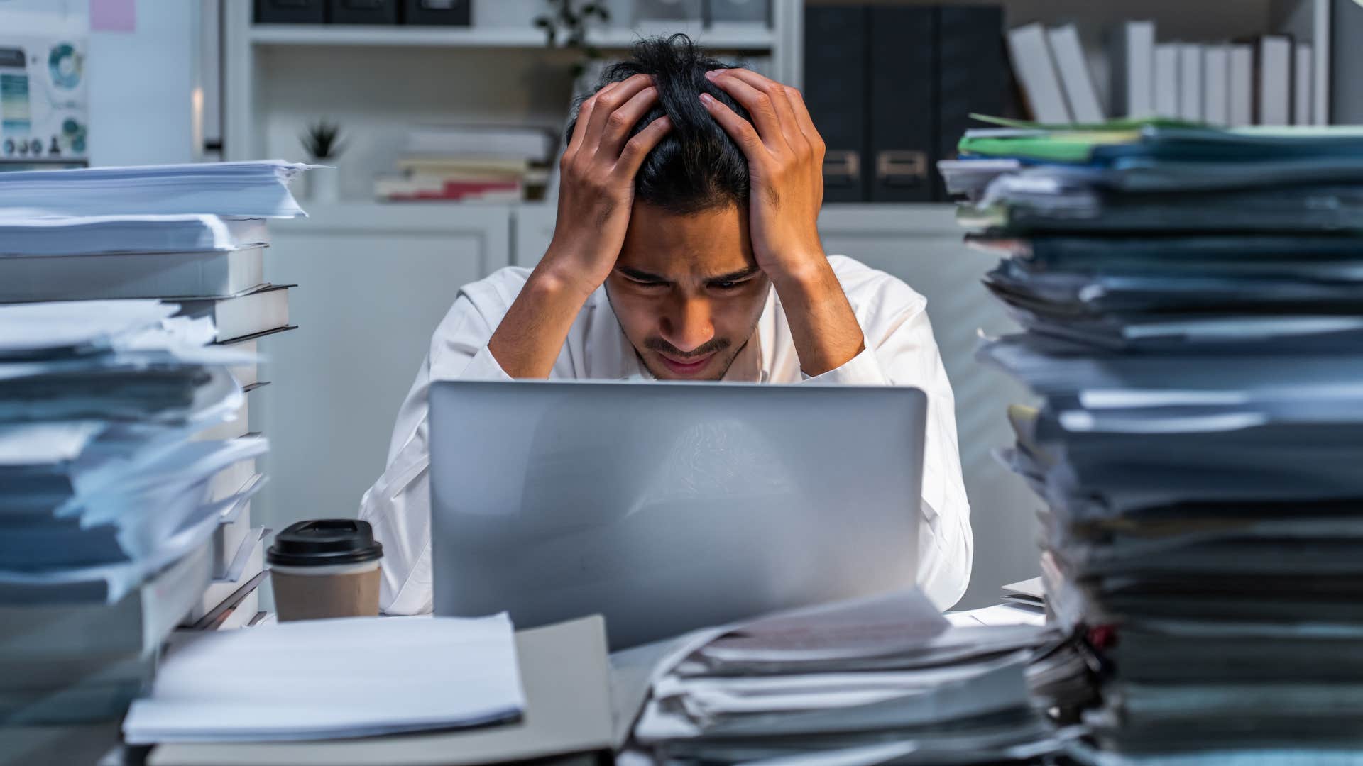 perfectionist man overworking himself feeling stressed