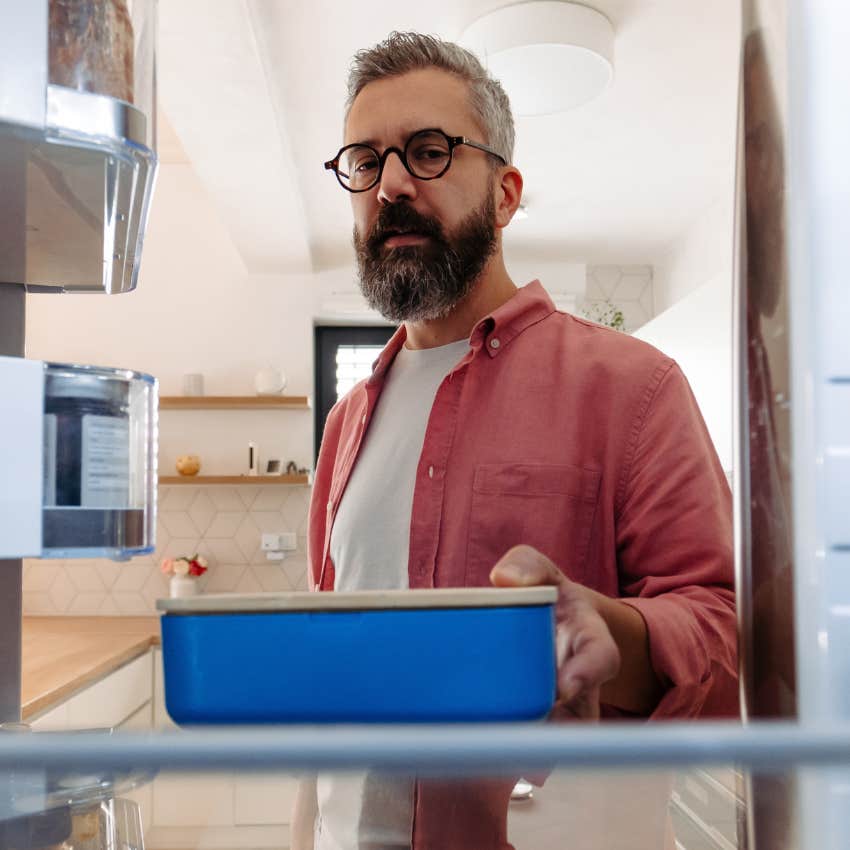 man putting away leftovers he brought home