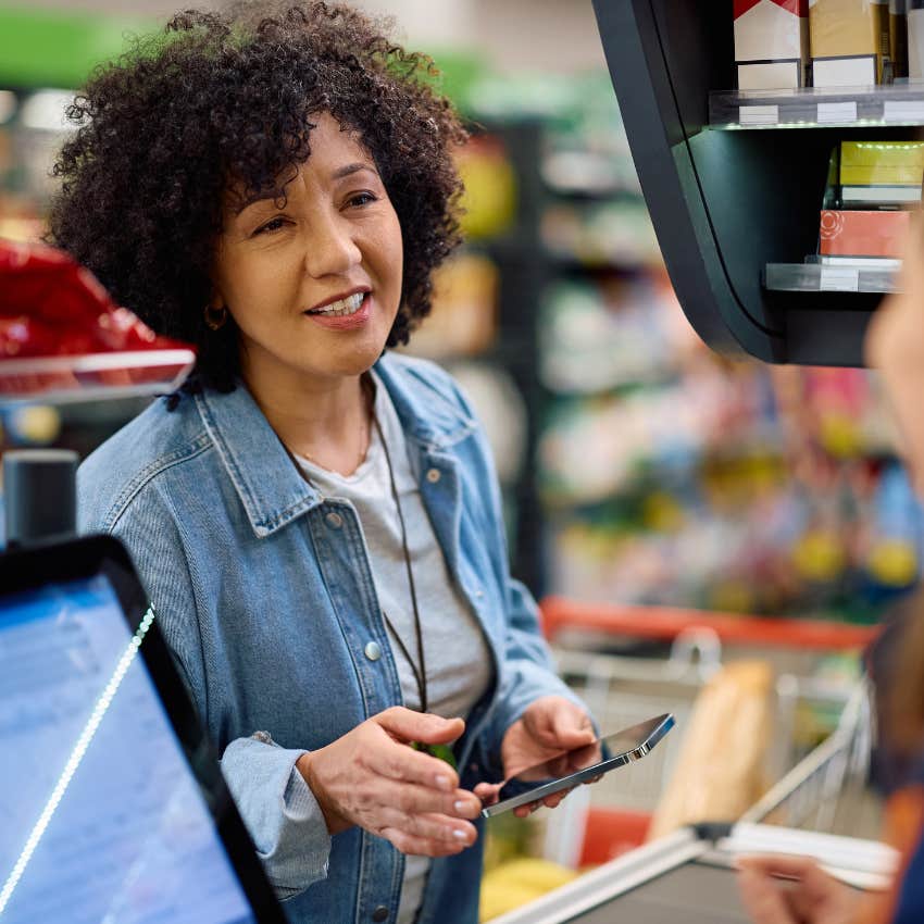 frugal american woman coupon hunting at the grocery store