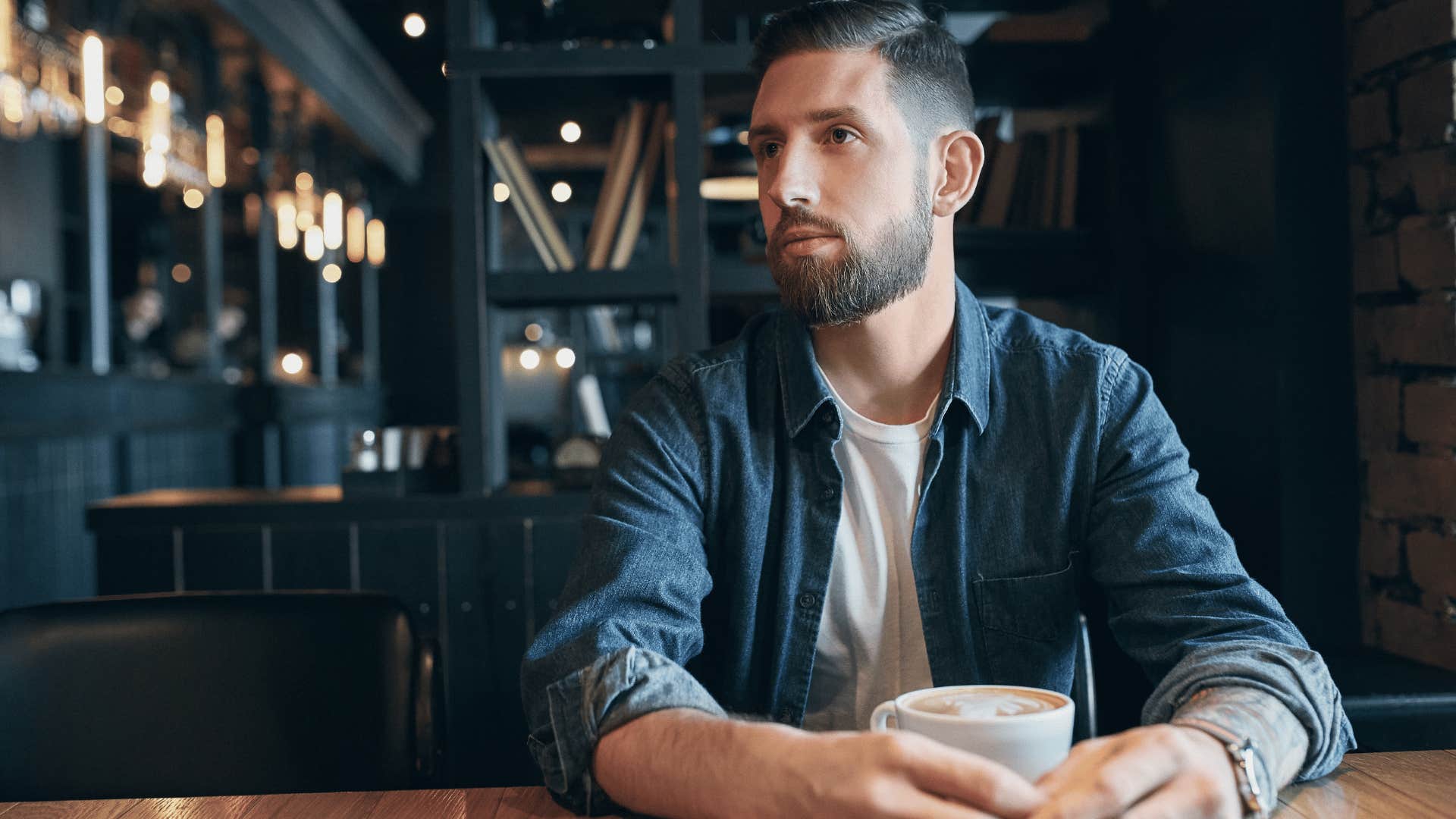 man at a cafe not looking at a menu until he needs to