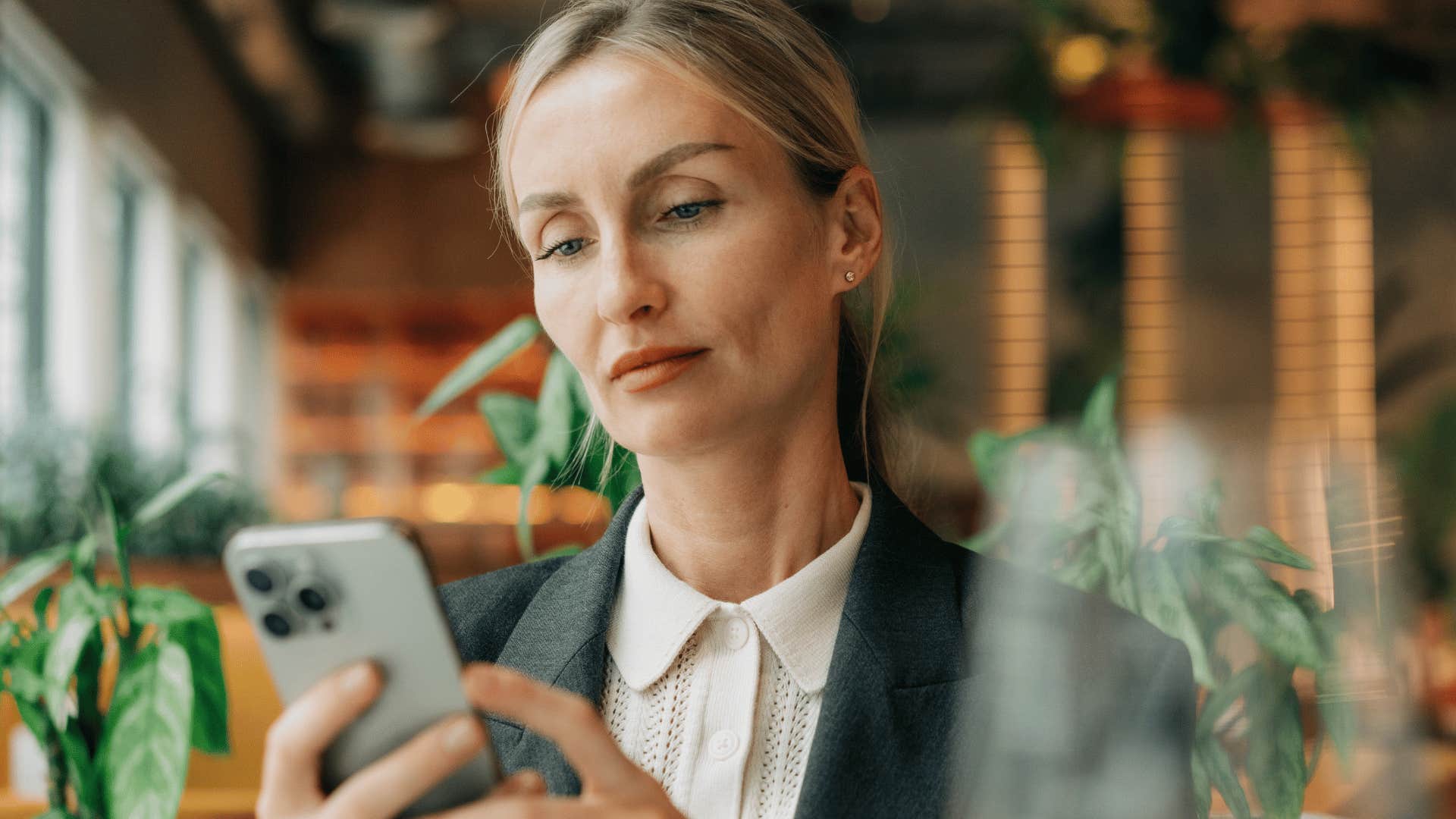 woman looking at her phone ordering the wrong things in a rush