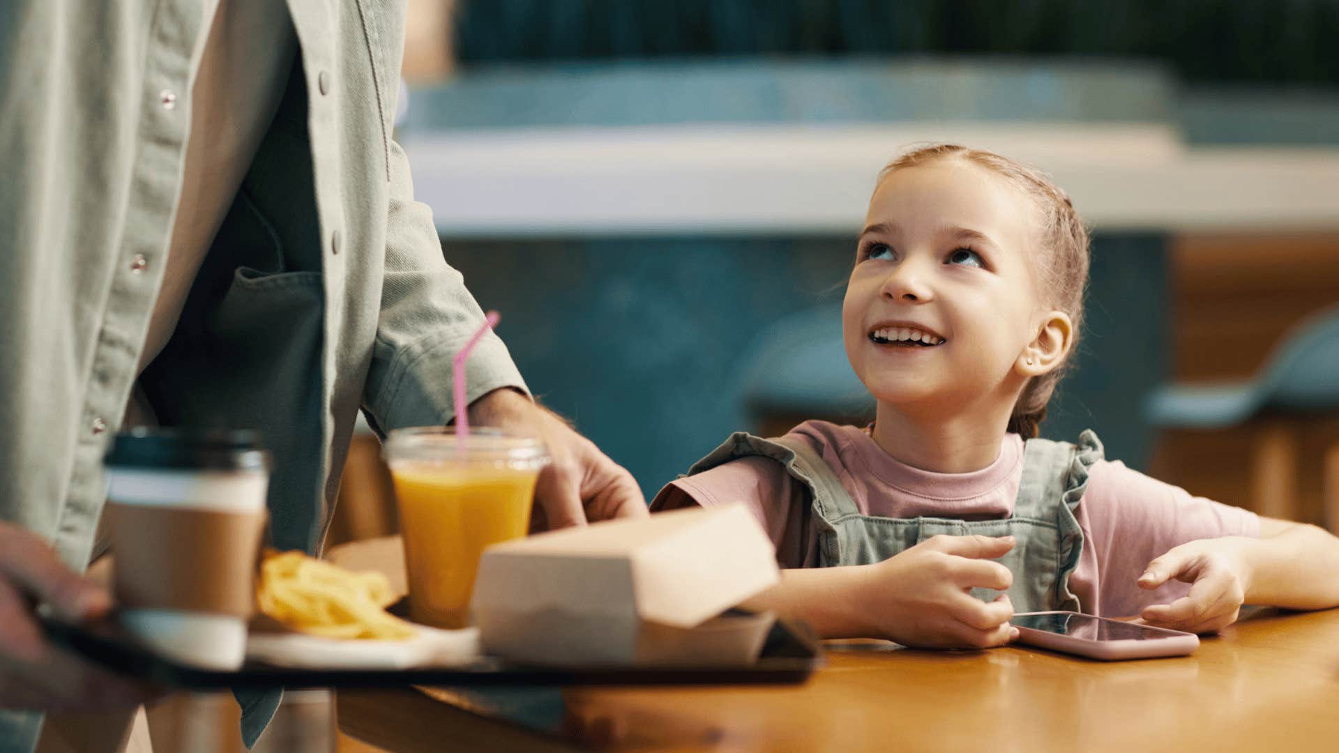 parent waiting for his kid to order at a restaurant