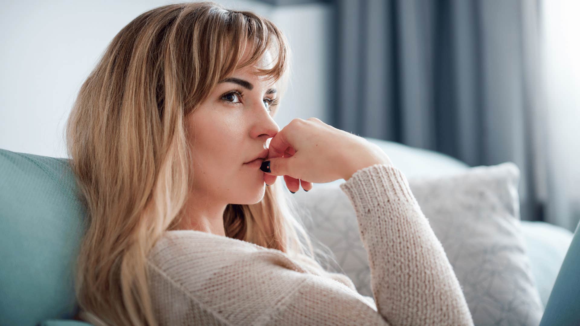 woman thinking deeply after getting an awkward text from a friend saying she just needs some space